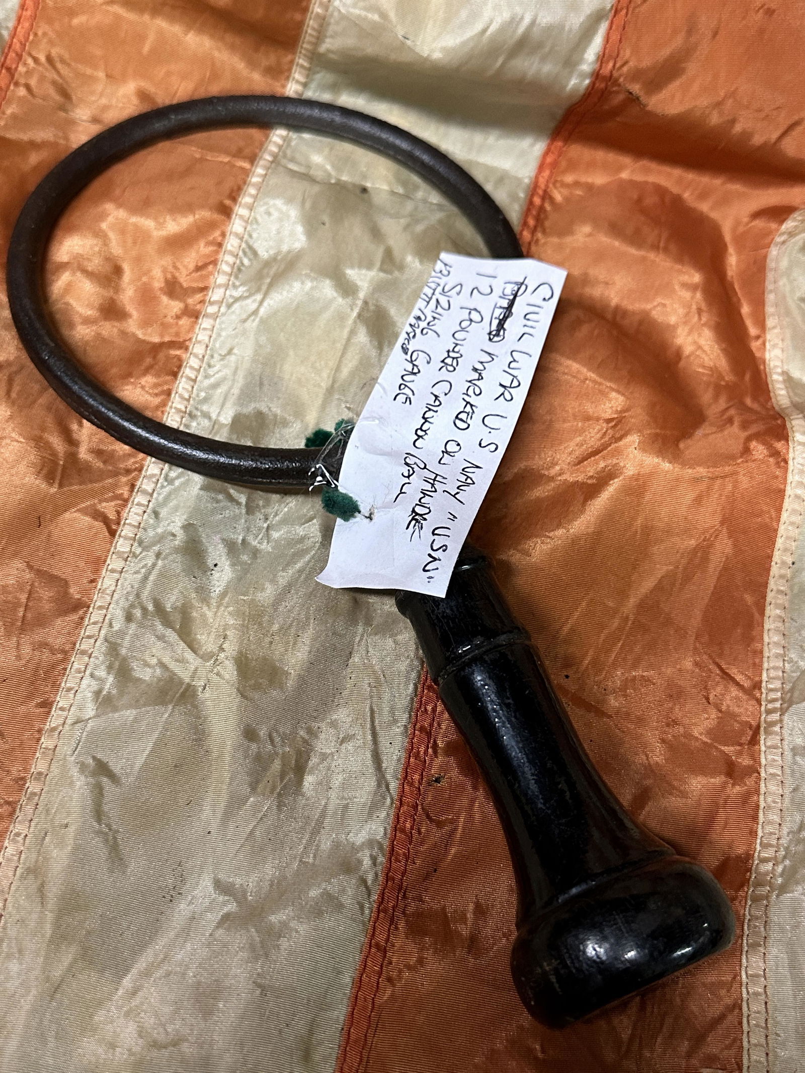 CIVIL WAR U.S. NAVY "U.S.N." 12 LB CANNON BALL SIZING GAUGE: CIVIL WAR U.S. NAVY "U.S.N." 12 LB CANNON BALL SIZING GAUGE. MARKED USN ON THE HANDLE. A RARE FIND. IT IS IN MINT OVERALL SHAPE AND CONDITION WITH A BEAUTIFUL OVERALL PATINA. COMES FROM A COLLECTION.