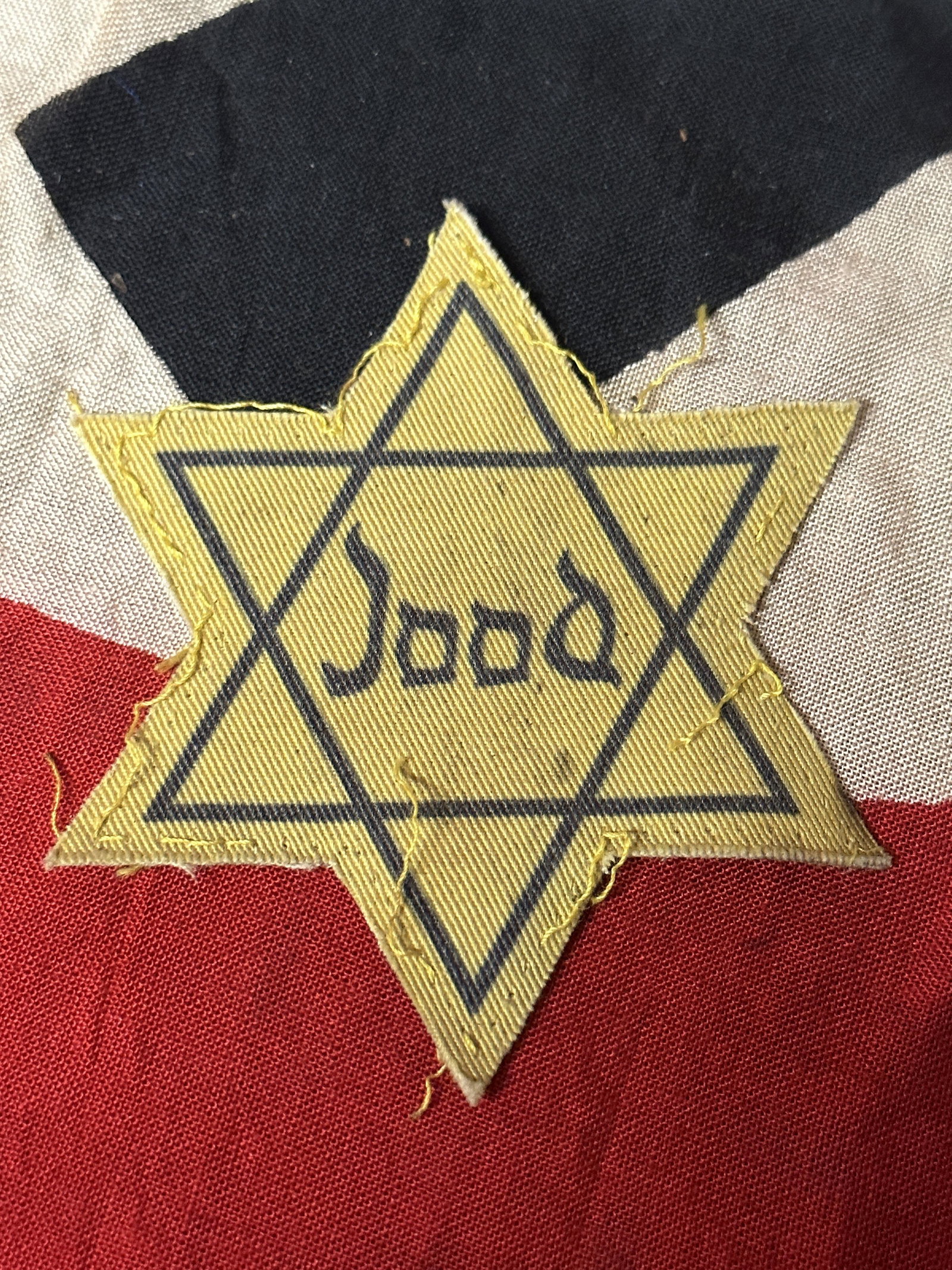 CUT OFF WW2 GERMAN JOOD STAR OF DAVID FROM CONCENTRATION CAMP: CUT OFF WW2 GERMAN JOOD STAR OF DAVID FROM CONCENTRATION CAMP. A VERY RARE AND SCARCE FIND THAT IS IN MINT OVERALL SHAPE AND CONDITION WITH A BEAUTIFUL OVERALL PATINA. SHOWS GOOD WEAR AND USE. PLEASE