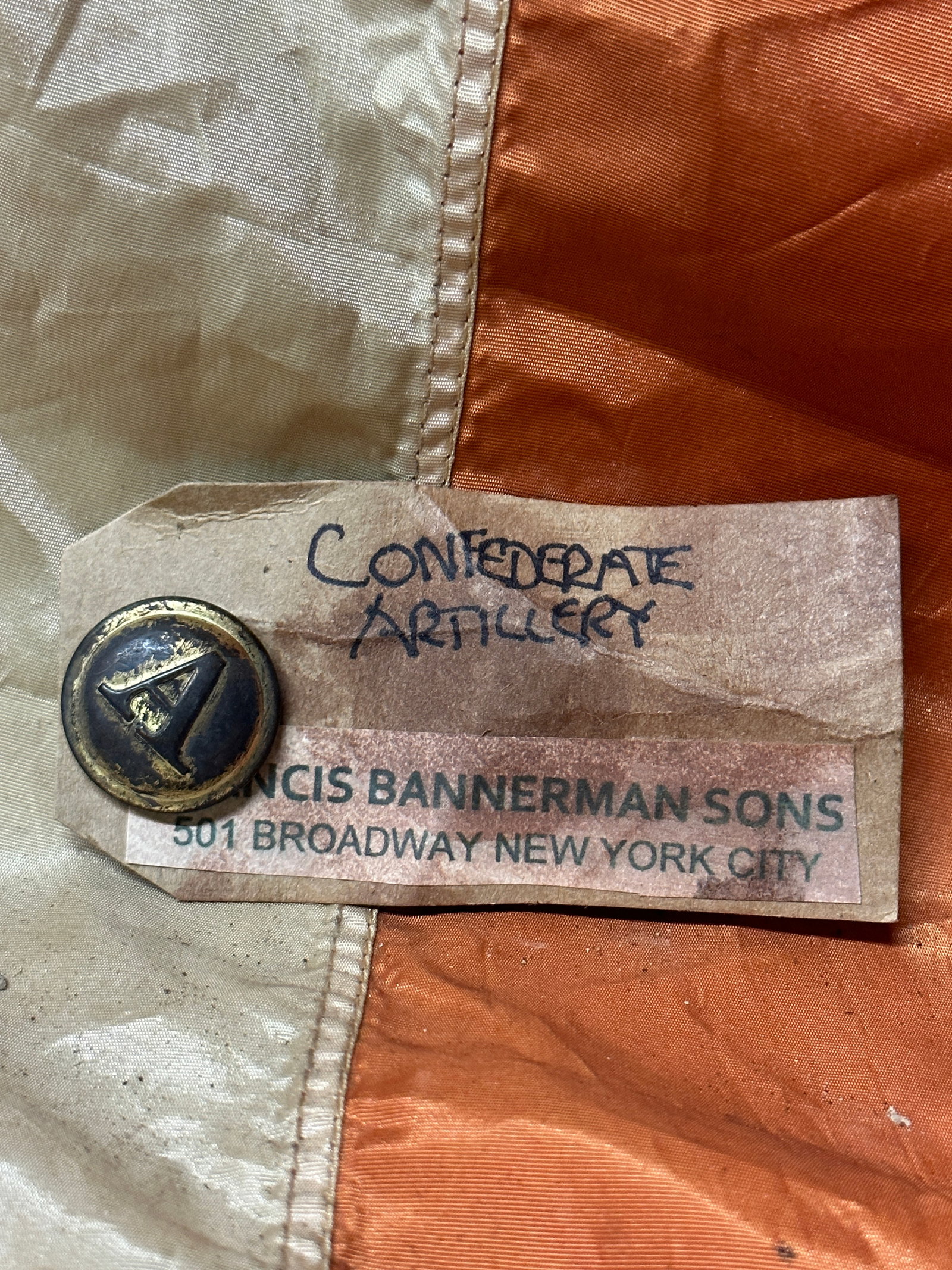 CIVIL WAR CONFEDERATE ARTILLERY BUTTON BY BANNERMAN: CIVIL WAR CONFEDERATE ARTILLERY BUTTON BY BANNERMAN. STILL HAS THE ORIGINAL MAKER MARK TAG ON IT. SHOWS GOOD WEAR AND USE. A GREAT FIND AND AN EXCELLENT ADDITION TO YOUR COLLECTION. A RARE FIND.