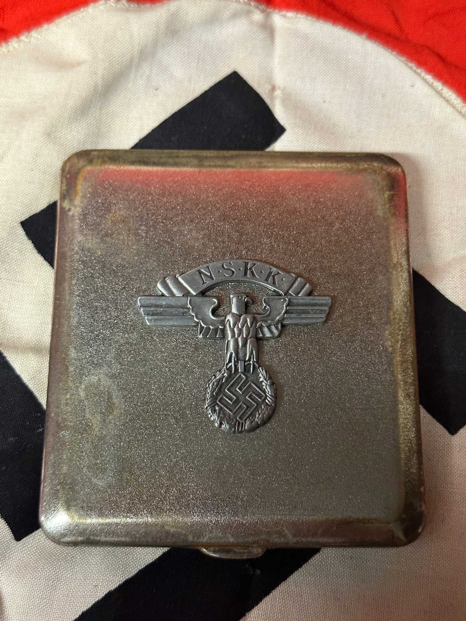 WW2 GERMAN NSKK CIGARETTE CASE - MAKER MARKED: WW2 GERMAN NSKK CIGARETTE CASE - MAKER MARKED. A RARE FIND. IT IS IN MINT OVERALL SHAPE AND CONDITION WITH A BEAUTIFUL OVERALL PATINA. SHOWS GOOD WEAR AND USE. PLEASE VIEW ALL DETAILED PICTURES. A RAR