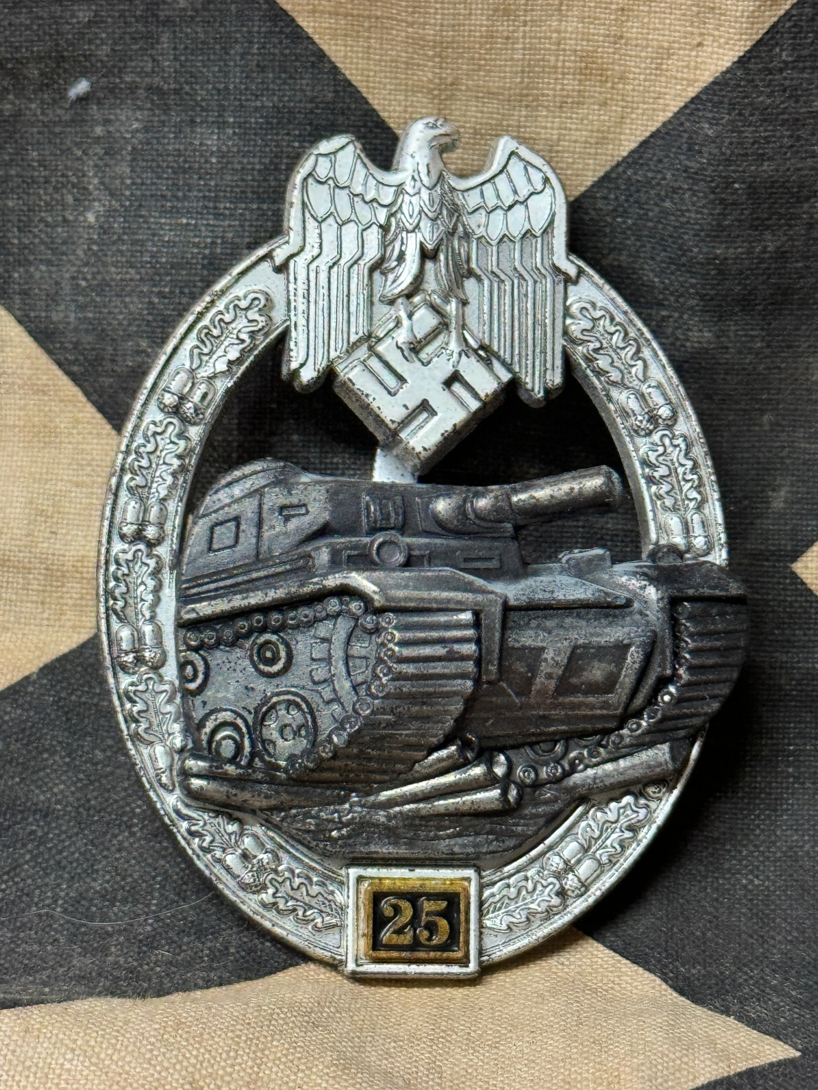 GERMAN WWII PANZER ASSAULT BADGE FOR 25 ENGAGEMENTS BY JFS: GERMAN WWII PANZER ASSAULT BADGE FOR 25 ENGAGEMENTS BY JFS. This numbered Panzer Assault Badge has a great look, with outstanding finish. Itâ€™s numbered â€œ25,” the lowest grade of the