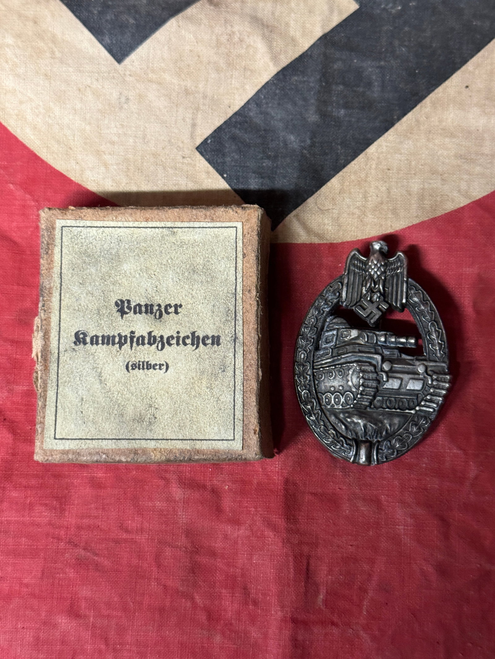 WW2 GERMAN PANZER 3RD REICH ASSAULT TANK BADGE IN SILVER IN ORIG. BOX: WW2 GERMAN PANZER 3RD REICH ASSAULT TANK BADGE IN SILVER IN ORIG. BOX. A VERY RARE FIND. PANZERKAMPFABZEICHEN IN SILVER. SHOWS GOOD WEAR AND USE WITH A BEAUTIFUL PATINA THROUGHOUT. A RARE FIND. PLEASE