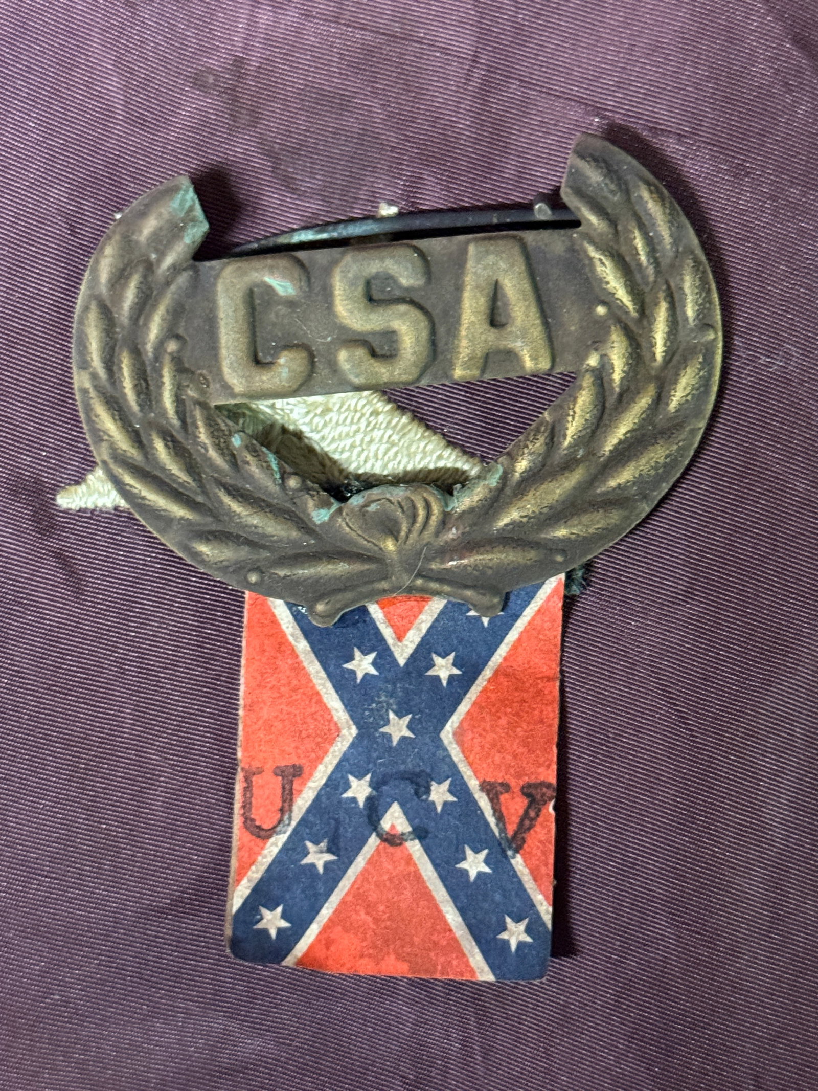 CIVIL WAR CONFEDERATE CSA WITH WREATHC UCV HAT BADGE INSIGNIA: CIVIL WAR CONFEDERATE CSA WITH WREATHC UCV HAT BADGE INSIGNIA. BEAUTIFULLY MADE WITH THE UCV PAPER FLAG ATTACHED TO IT. WAS USED IN UCV PARADES AND MEETINGS. PLEASE VIEW ALL DETAILED PICTURES. A GREAT
