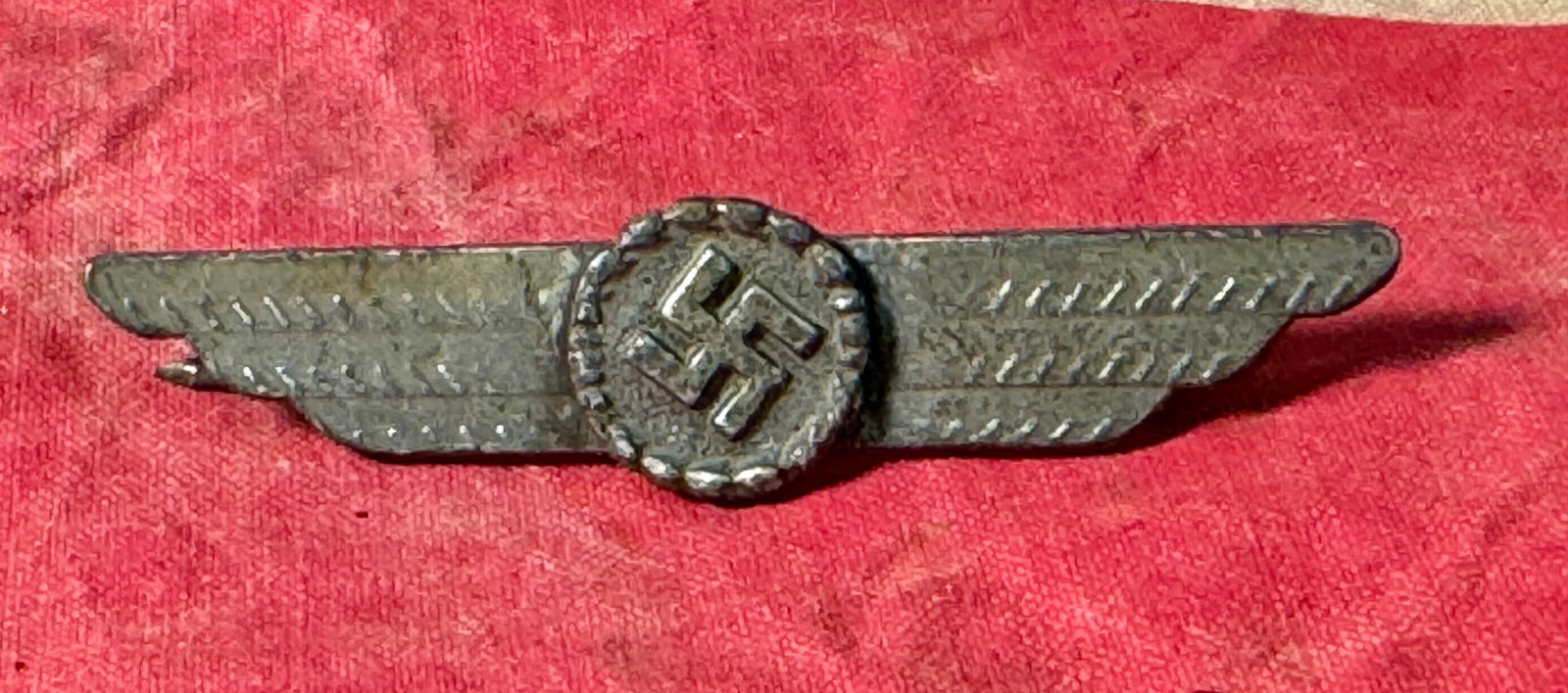 WW2 German Luftwaffe Civil Fire Brigade Visor Cap Insignia: WW2 German Luftwaffe Civil Fire Brigade Visor Cap Insignia. The insignia shows age toning and verdigris. All attachment prongs are intact. A rare find.