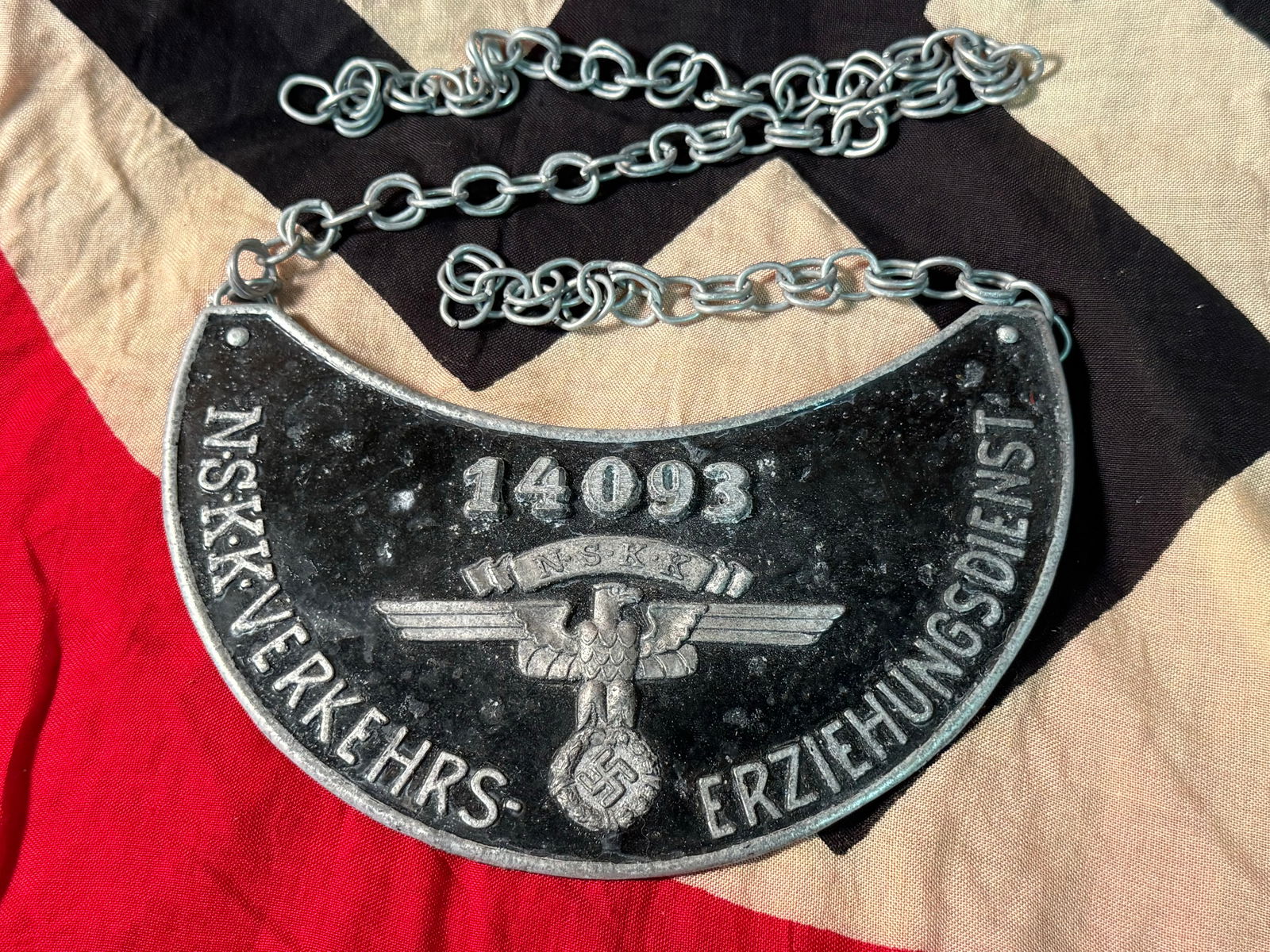 A gorget for a WW2 German member of the NSKK Traffic Education Service: A gorget for a WW2 German member of the NSKK Traffic Education Service. Kidney-shaped, black lacquered aluminium shield with unpainted flared edge and integrated, stamped 2nd model NSKK eagle with ins