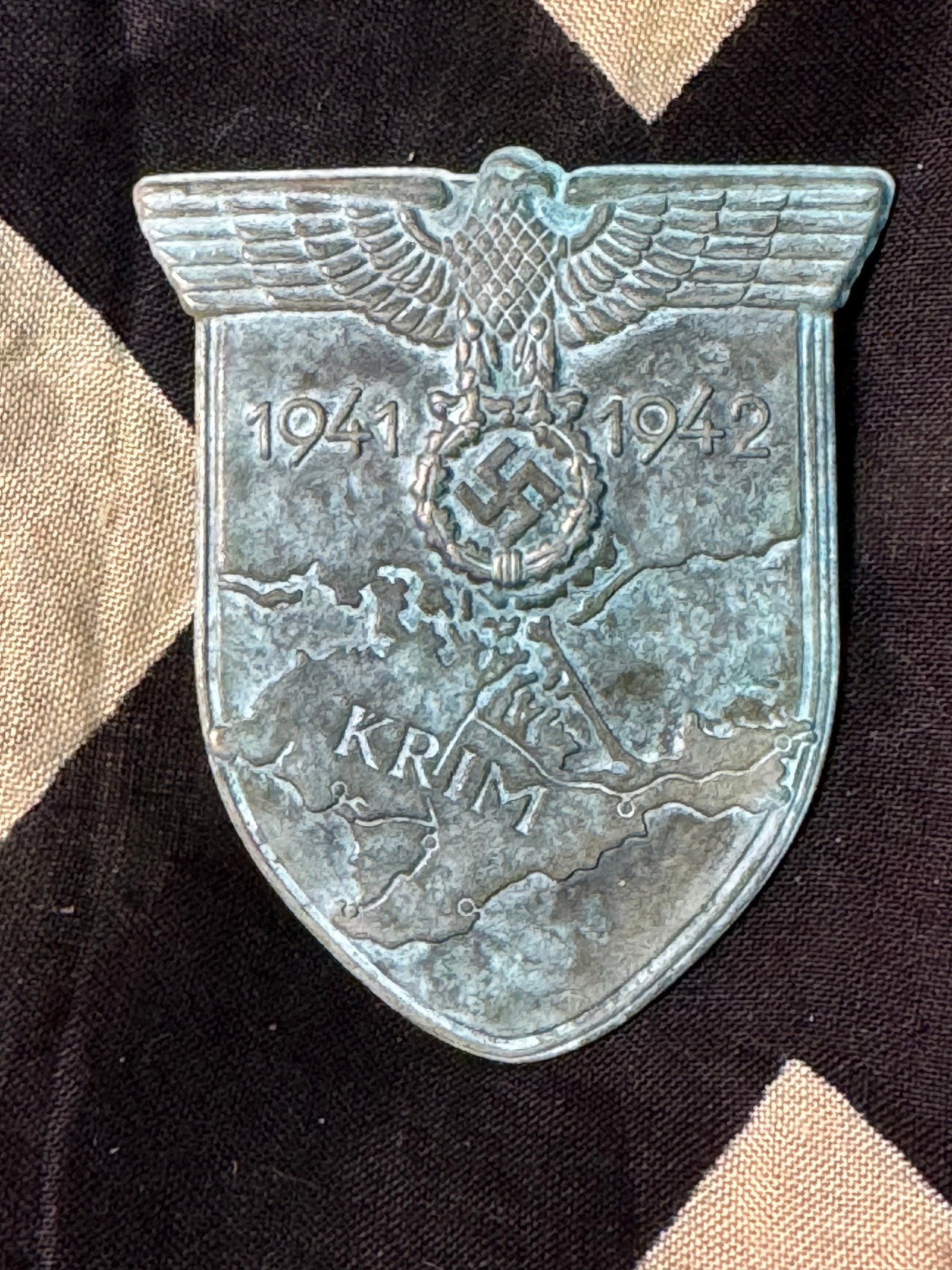 WW2 Germany KRIM Soviet Service Shield Badge: WW2 Germany KRIM Soviet Service Shield Badge. A VERY RARE FIND. IT IS IN MINT OVERALL SHAPE AND CONDITION WITH A BEAUTIFUL OVERALL PATINA. SHOWS GOOD WEAR AND USE. A WELL MADE RARE ARTIFACT.