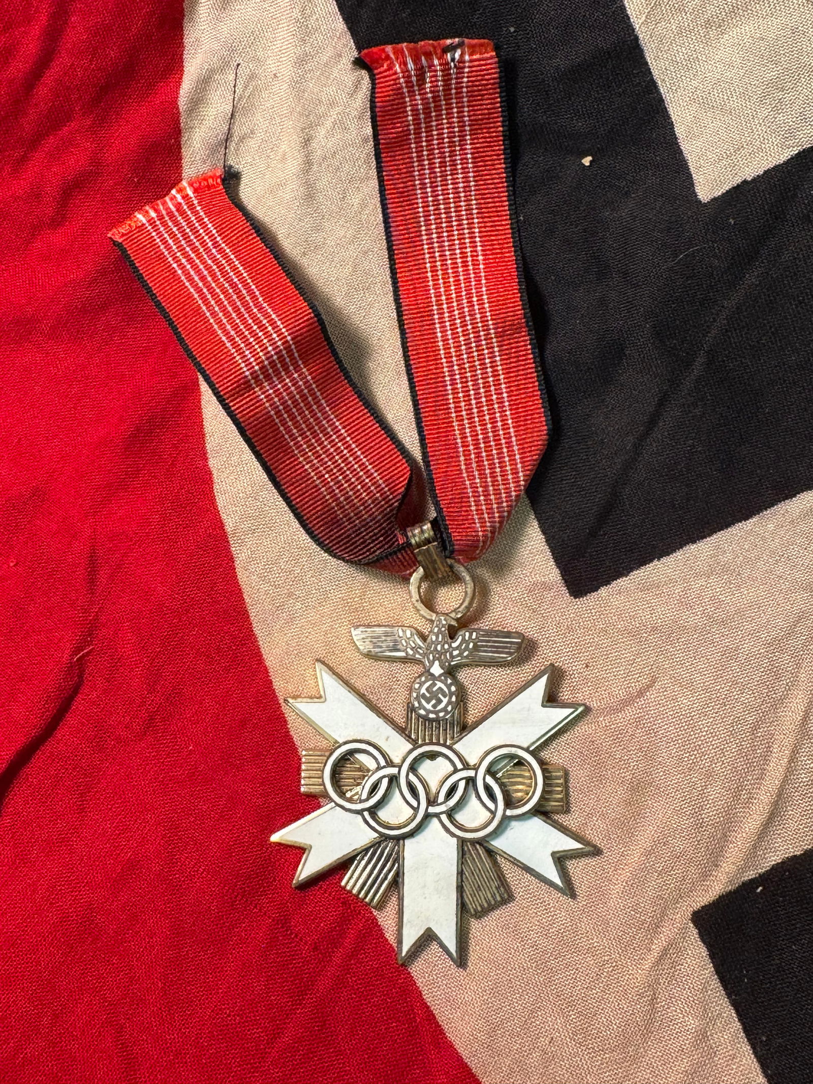 WW2 German Olympic Decoration 1936, 2nd Class Cross With Ribbon: WW2 German Olympic Decoration 1936, 2nd Class Cross With Ribbon. The German Olympic Decoration was a civil decoration awarded to administrators of the IV Olympic Winter Games in Garmisch-Partenkirchen