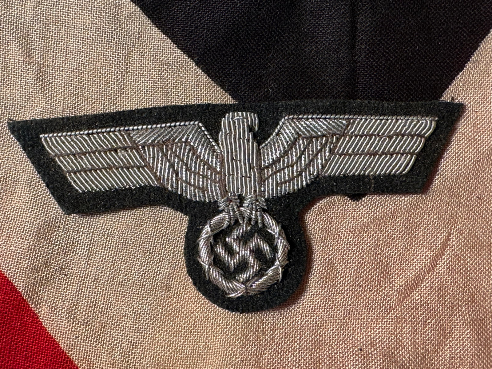 GERMAN WWII ARMY OFFICER BULLION TUNIC EAGLE: GERMAN WWII ARMY OFFICER BULLION TUNIC EAGLE. Silver wire embroidery on dark green wool badge cloth. Shows good wear and use with a beautiful patina throughout. Please view all detailed pictures. A ra