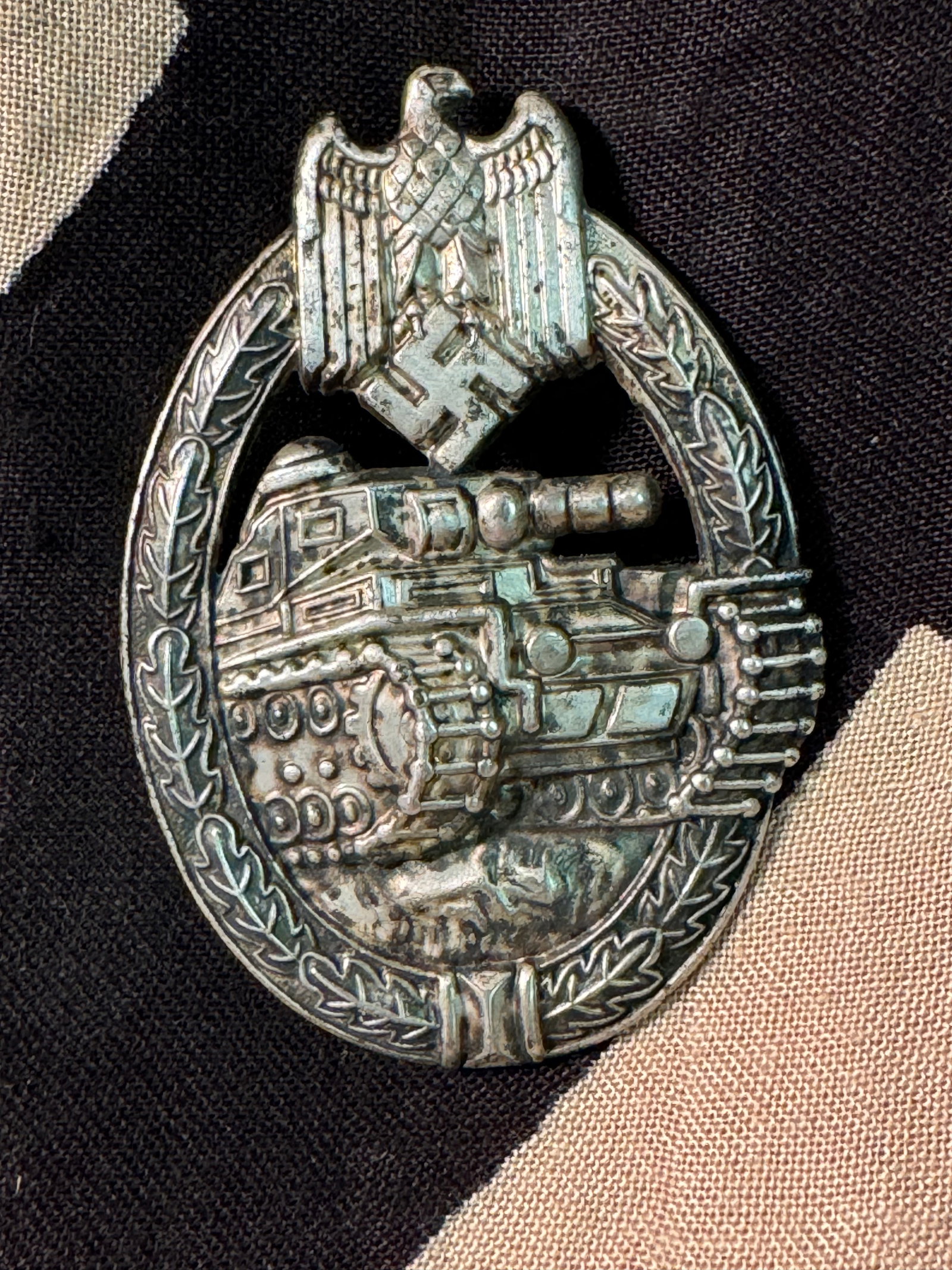 GERMAN WWII TANK ASSAULT BADGE IN SILVER: GERMAN WWII TANK ASSAULT BADGE IN SILVER. Late War, zinc badge with original silver wash in the recesses of the obverse. Shows good wear and use with a beautiful patina throughout. Please view all det