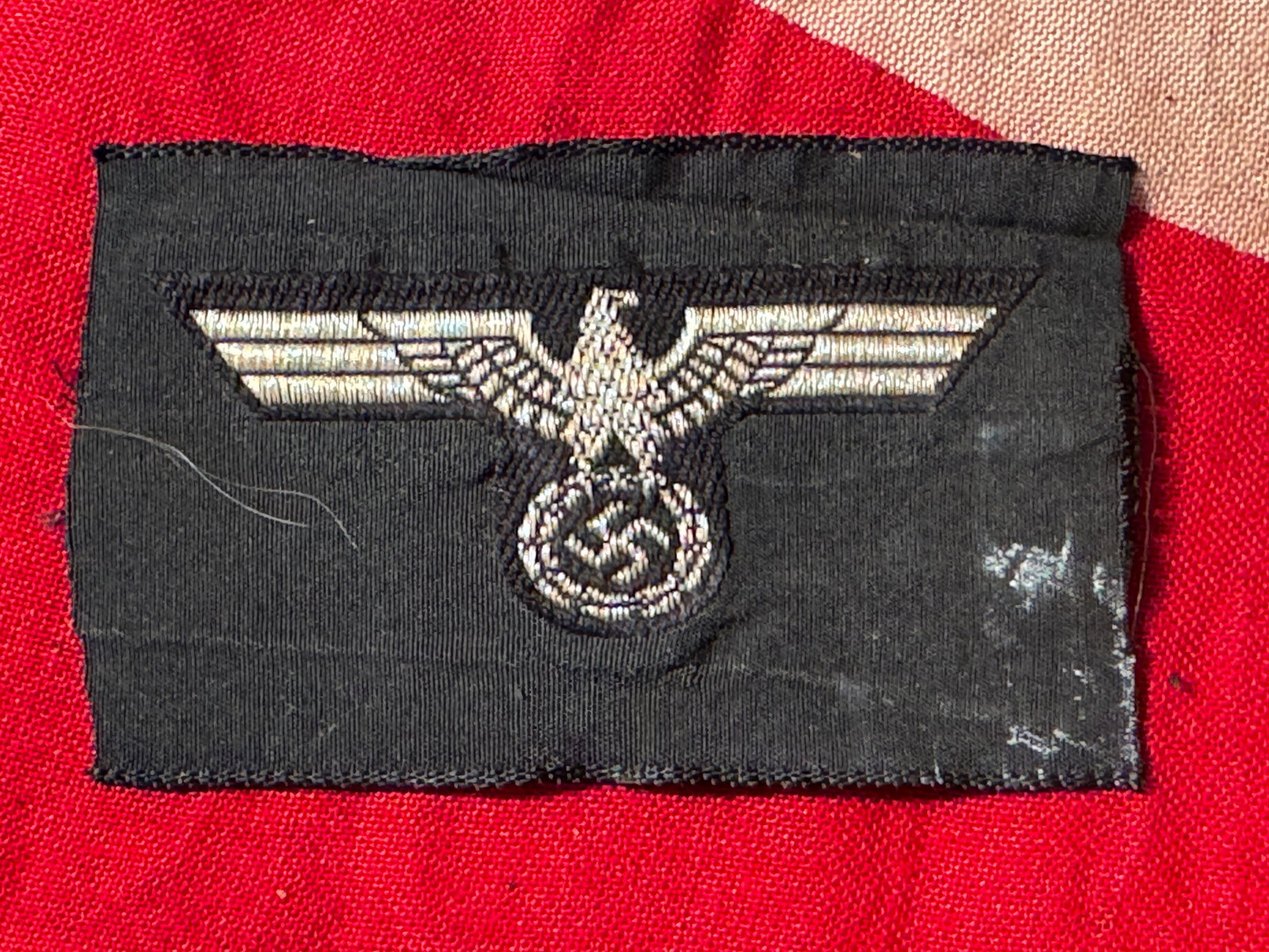 German WWII Heer Panzer Enlisted Tunic Eagle: German WWII Heer Panzer Enlisted Tunic Eagle. Original era manufacture. BeVo pattern embroidery on black material, appears to have been cut from a roll. Stock photo, minor details will vary.