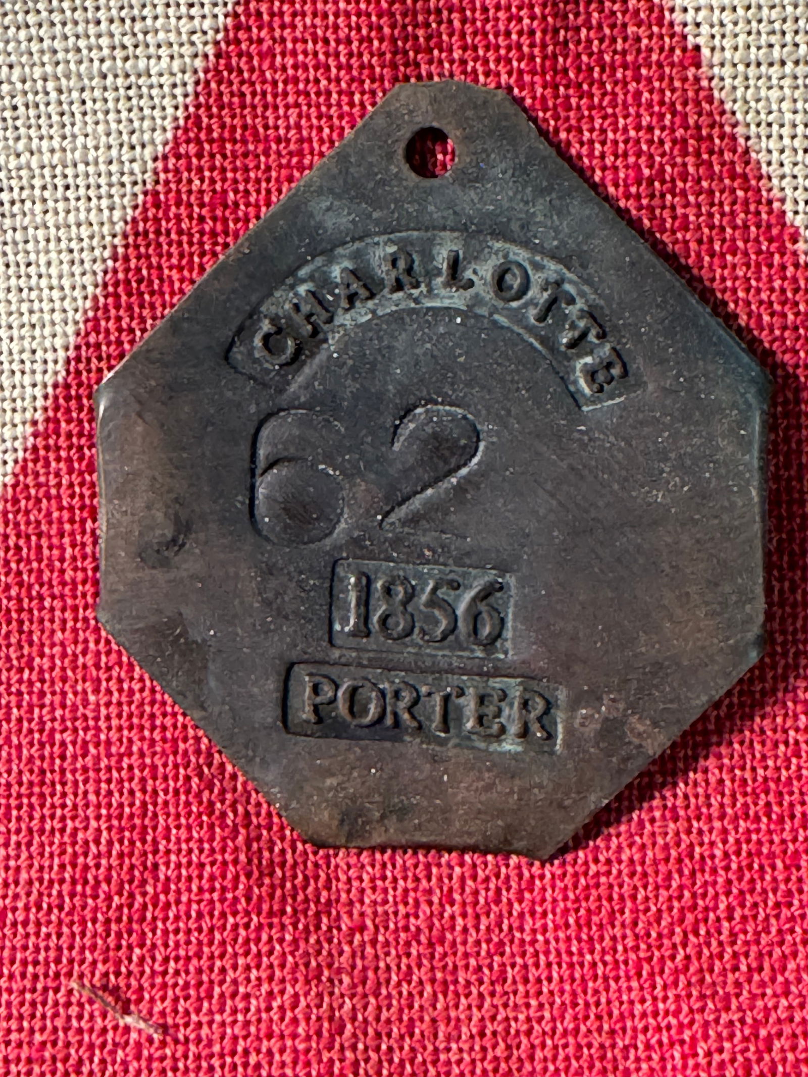 DATED 1856 CHARLOTTE #62 PORTER SLAVE SERVANT TAG: DATED 1856 CHARLOTTE #62 PORTER SLAVE SERVANT TAG. A RARE FIND. IT IS IN MINT OVERALL SHAPE AND CONDITION WITH A BEAUTIFUL OVERALL PATINA. HAS A GREAT LOOK TO IT WITH AN EXCELLENT OVERALL EYE APPEAL.