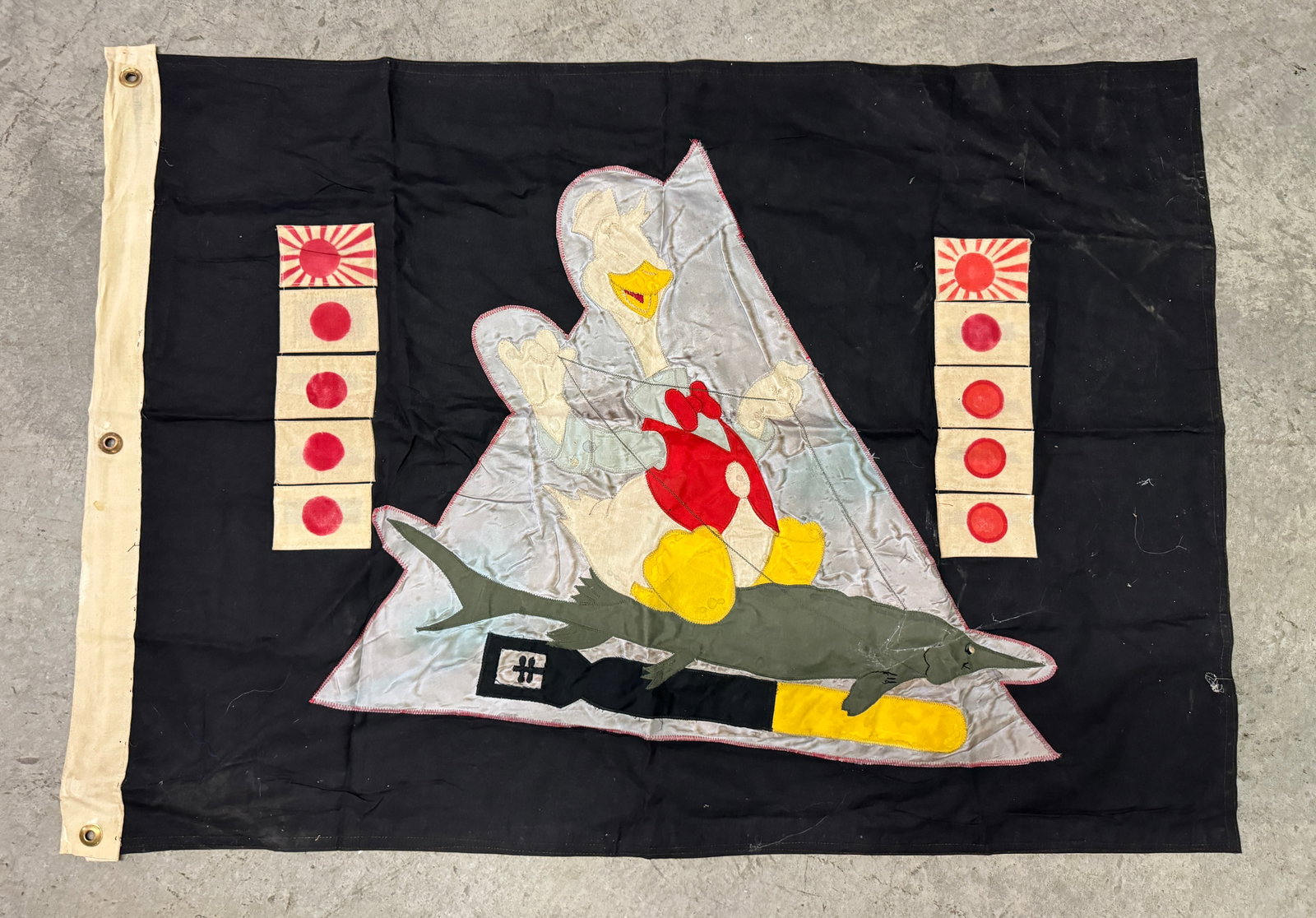 WW2 USN NAVAL USS HACKLEBACK SS-295 SUBMARINE KILL FLAG: WW2 USN NAVAL USS HACKLEBACK SS-295 SUBMARINE KILL FLAG. The front shows a duck riding a fish with a torpedo below. Has the kills of each ship on both sides of the duck. It reads 'SS-295 USS Hacklebac