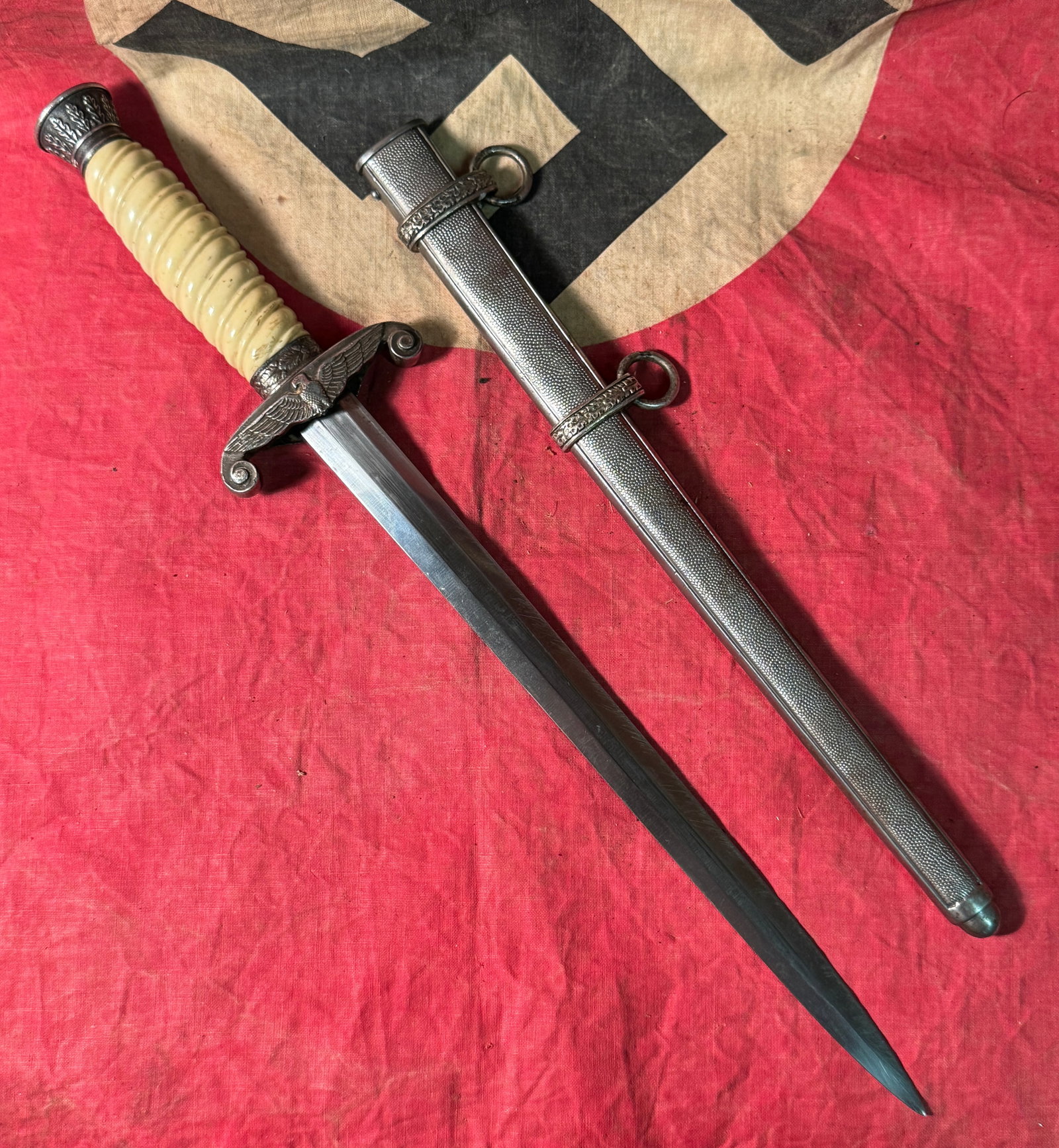 WW2 GERMAN ARMY POW OFFICER DAGGER WITH SCABBARD: WW2 GERMAN ARMY POW OFFICER DAGGER WITH SCABBARD. THE SWASTIKA IS REMOVED/FILED DOWN BY THE POW. SHOWS GOOD WEAR AND USE WITH A BEAUTIFUL OVERALL PATINA. PLEASE VIEW ALL DETAILED PICTURES. A VERY RARE