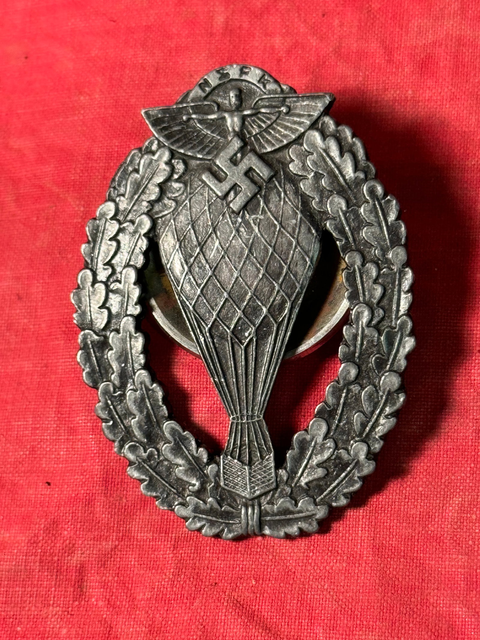 WW2 German N.S.F.K. Pilot Ballon - in Silver: WW2 German N.S.F.K. Pilot Ballon - in Silver with a screw back construction. The National Socialist Flyers Corps (German: Nationalsozialistisches Fliegerkorps; NSFK) was a paramilitary organization of