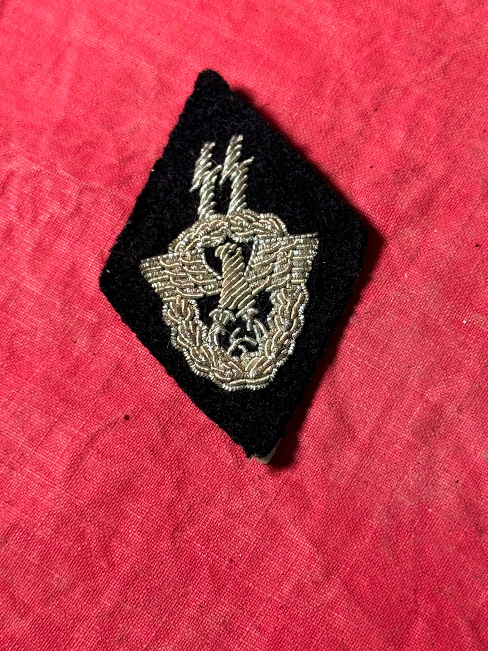 GERMAN WWII REICH CENTRAL SECURITY OFFICE ARM PATCH: GERMAN WWII REICH CENTRAL SECURITY OFFICE ARM PATCH. A rare piece of SS insignia being a lozenge shaped SS runes above the police insignia arm shield, introduced in February 1943, it was for assignmen