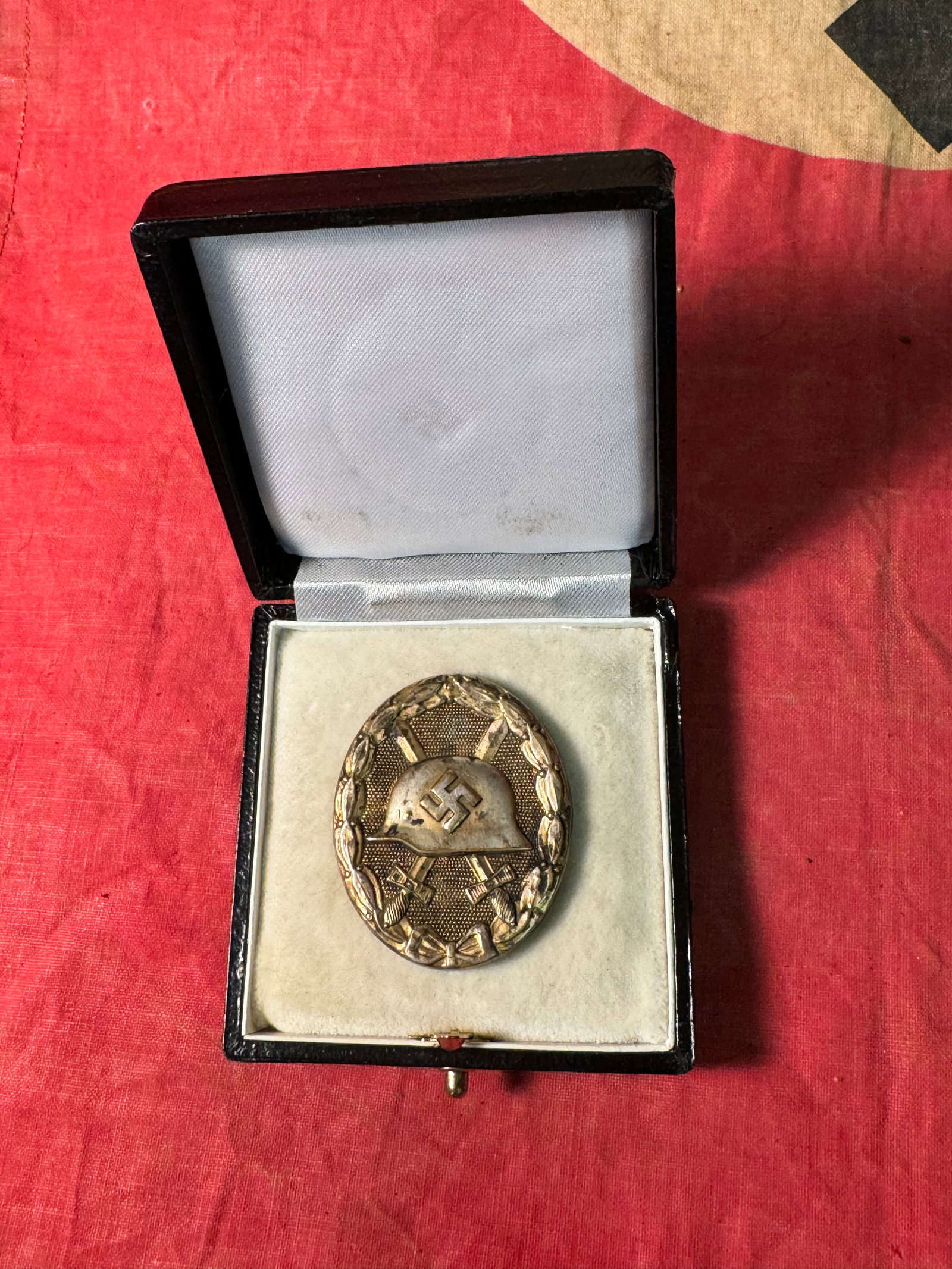 CASED WW2 GERMAN WOUND BADGE IN GOLD: CASED WW2 GERMAN WOUND BADGE IN GOLD. A SCARCE ITEM. SHOWS GOOD WEAR AND USE WITH A BEAUTIFUL OVERALL PATINA. PLEASE VIEW ALL DETAILED PICTURES. A WELL MADE ANTIQUE GERMAN ARTIFACT.