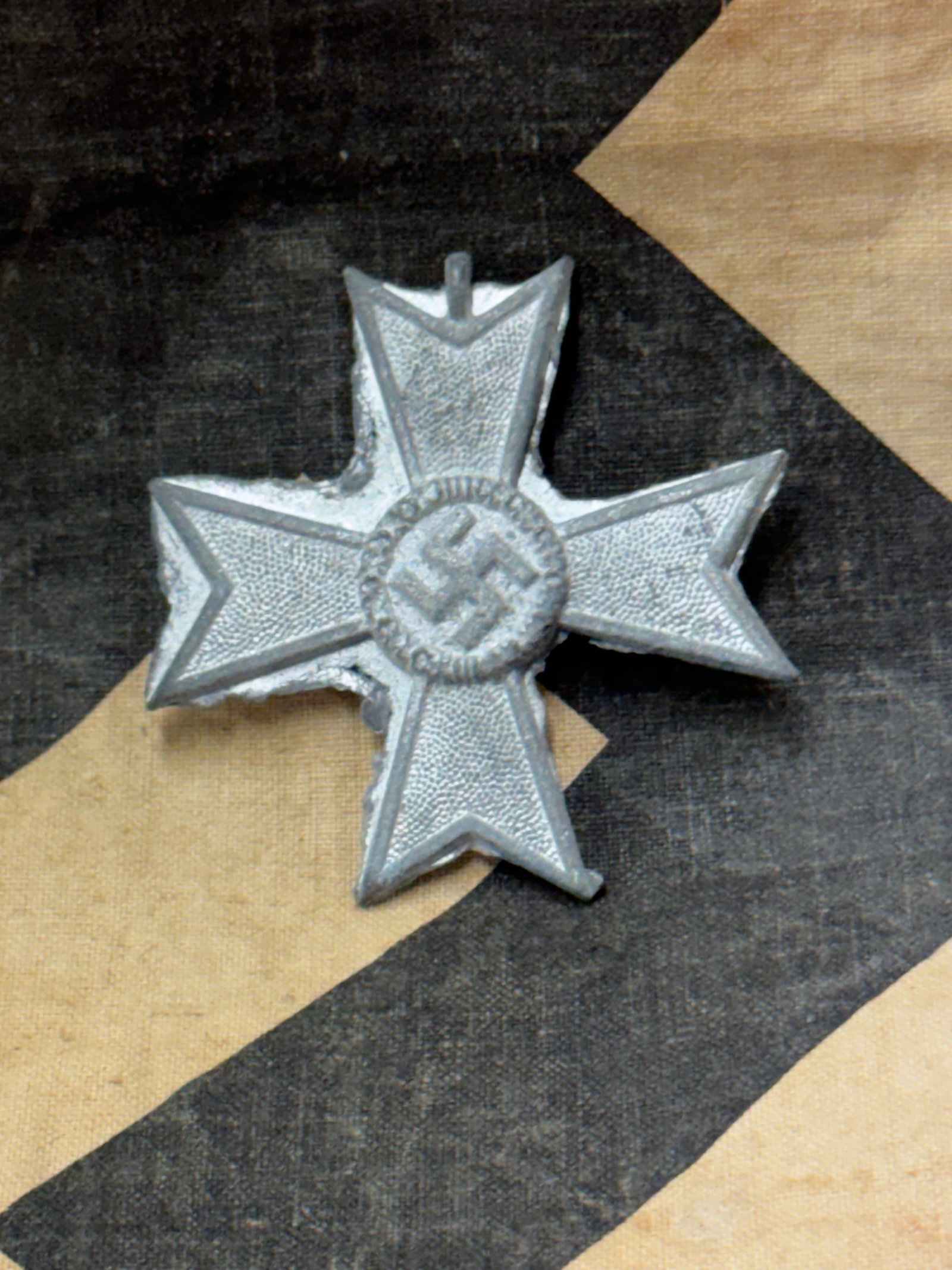 FACTORY UNCUT WW2 GERMAN MERIT CROSS IN SILVER: FACTORY UNCUT WW2 GERMAN MERIT CROSS IN SILVER. A SCARCE FIND. SHOWS GOOD WEAR AND USE WITH A BEAUTIFUL OVERALL PATINA. THIS IS AN UN-CUT VERSION FROM THE FACTORY. A RARE SPECIMEN.