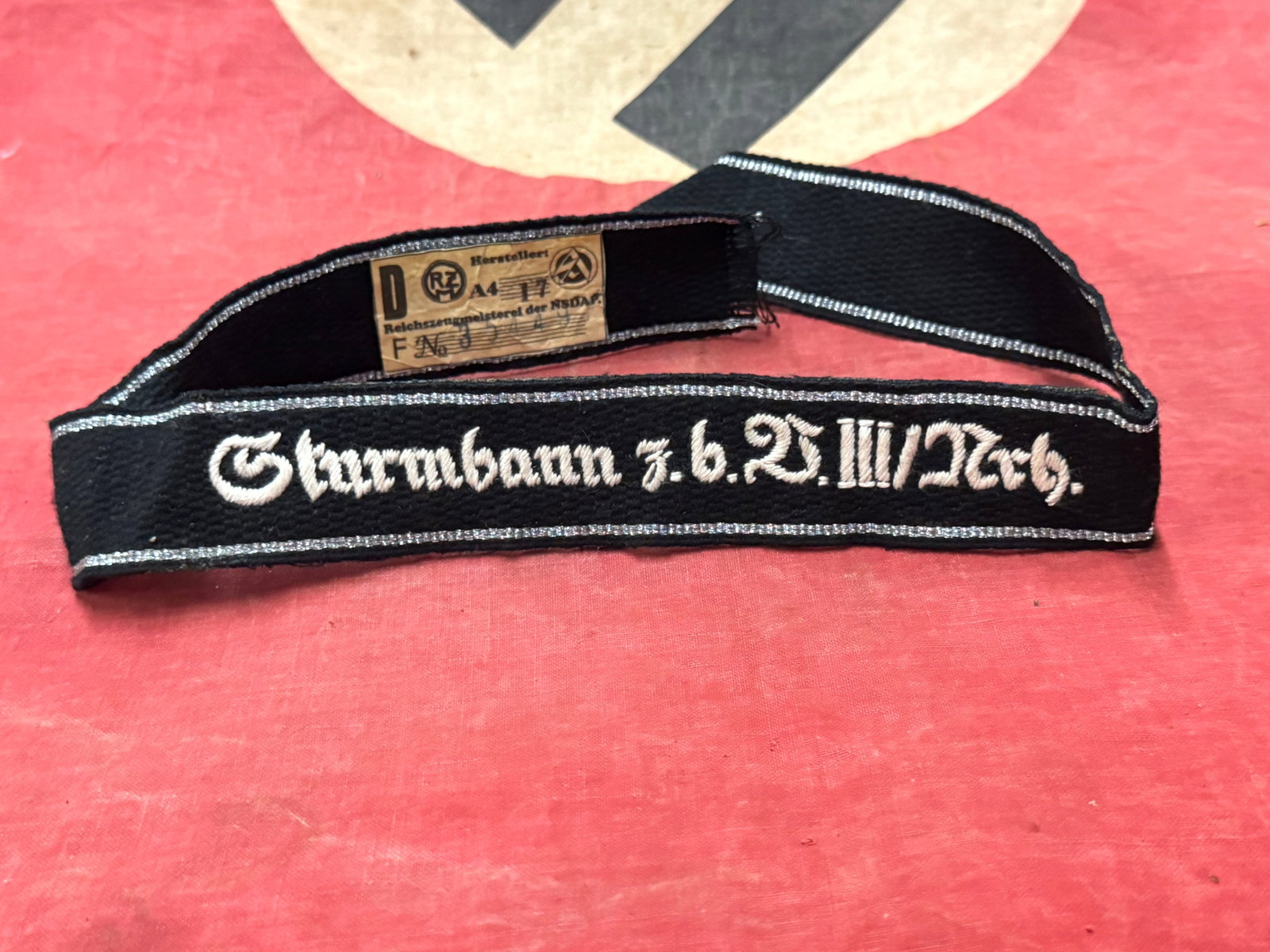RARE WW2 GERMAN WAFFEN SS STURMBANN CUFF TITLE WITH RZM PAPER TAG: RARE WW2 GERMAN WAFFEN SS STURMBANN CUFF TITLE WITH RZM PAPER TAG. A SCARCE EXAMPLE. SHOWS GOOD WEAR AND USE WITH A BEAUTIFUL OVERALL PATINA. PLEASE VIEW ALL DETAILED PICTURES. A WELL MADE ANTIQUE GER