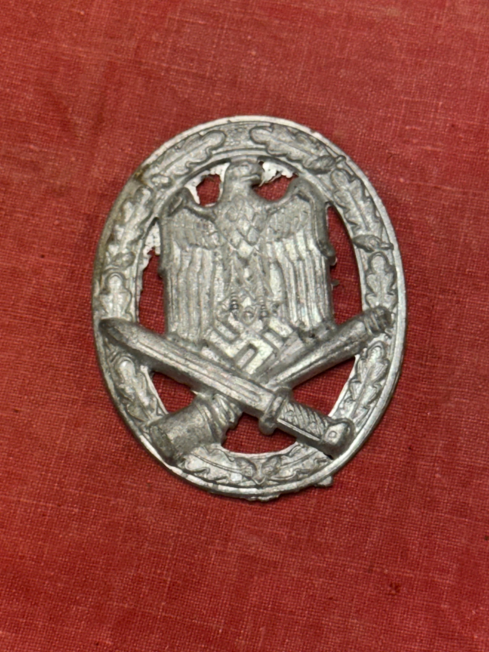 WW2 GERMAN GENERAL ASSAULT BADGE BY ALOIS RETTENMAIER: WW2 GERMAN GENERAL ASSAULT BADGE BY ALOIS RETTENMAIER. General Assualt Badge (Allgemeines-Sturmabzeichen) constructed in silvered-plated zinc. Has the maker mark on the reverse but missing the pin lat