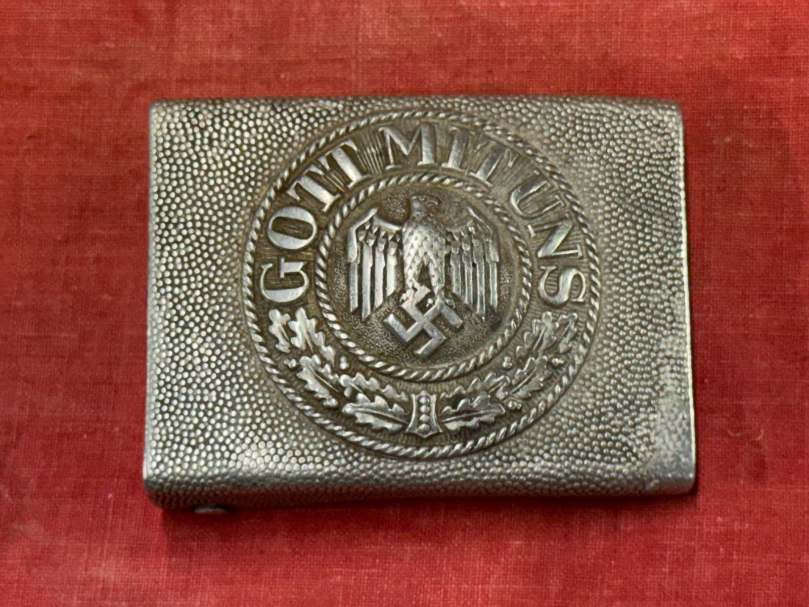 WW2 GERMAN GOTT MIT UNS BELT BUCKLE IN SILVER: WW2 GERMAN GOTT MIT UNS BELT BUCKLE IN SILVER. A SCARCE FIND. SHOWS GOOD WEAR AND USE WITH A BEAUTIFUL OVERALL PATINA. PLEASE VIEW ALL DETAILED PICTURES. A VERY RARE FIND.