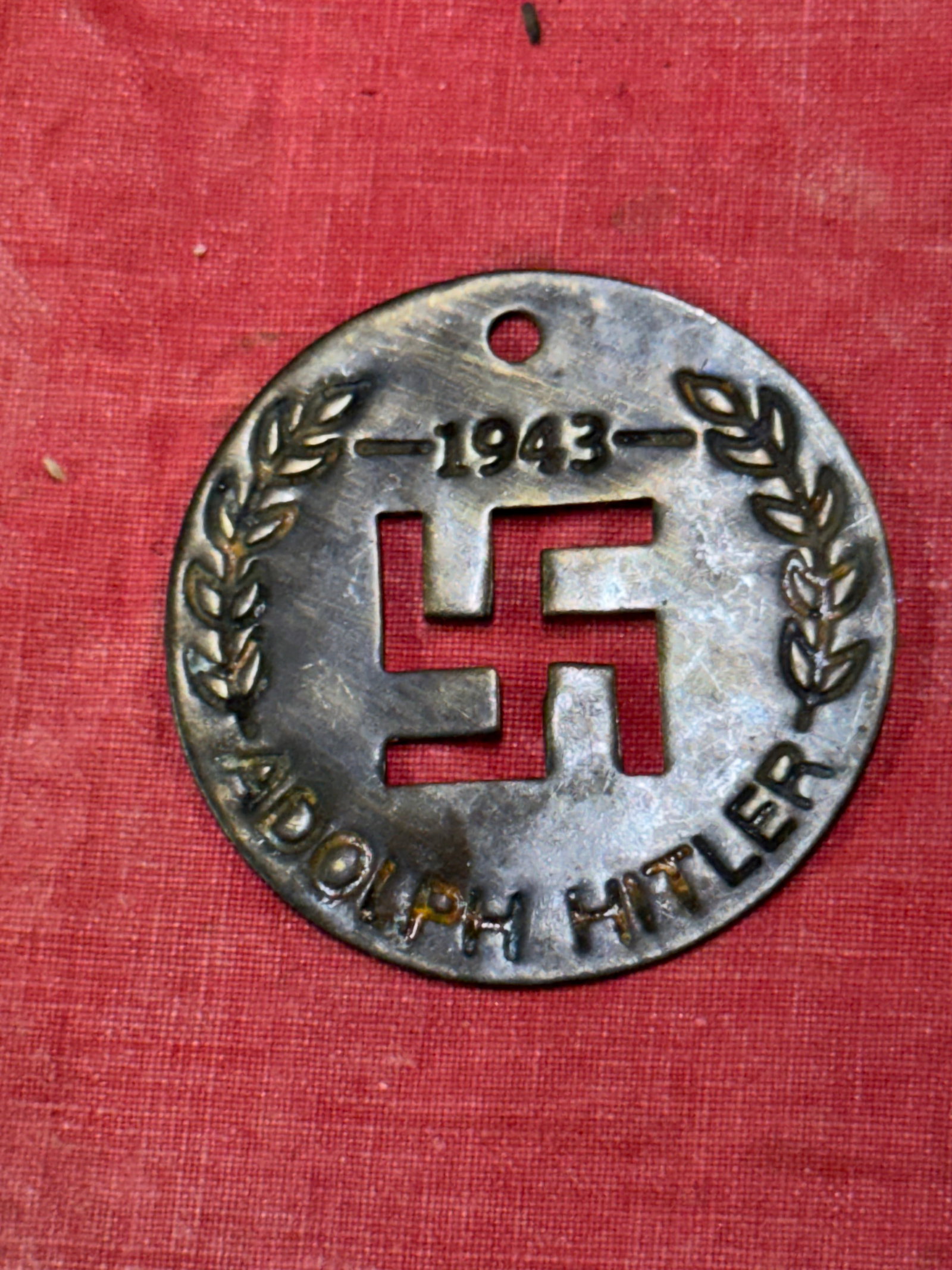 VERY RARE WW2 GERMAN 1943 ADOLF HITLER PENDANT: VERY RARE WW2 GERMAN 1943 ADOLF HITLER PENDANT OR TAG. SHOWS GOOD WEAR AND USE WITH A BEAUTIFUL PATINA THROUGHOUT. PLEASE VIEW ALL DETAILED PICTURES. A WELL MADE ANTIQUE GERMAN ARTIFACT.