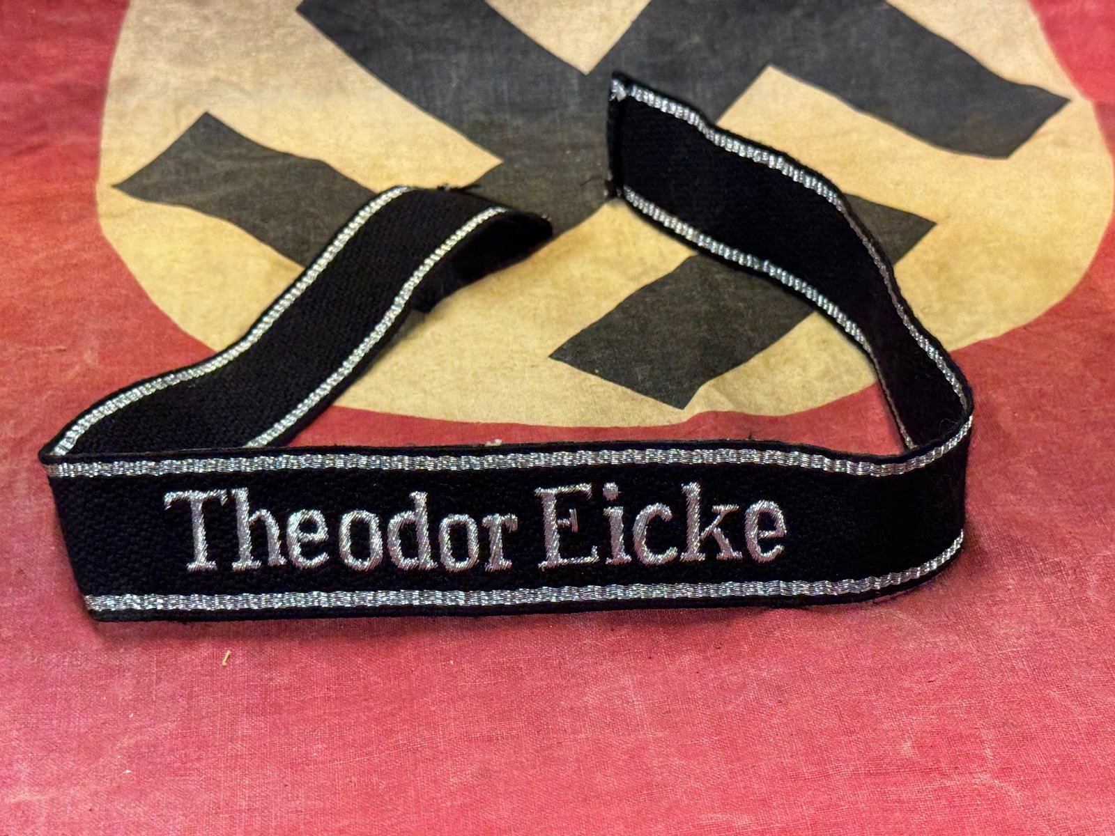 WW2 GERMAN SS CUFF TITLE "THEODOR EICKE": WW2 GERMAN SS CUFF TITLE "THEODOR EICKE". A SCARCE EXAMPLE. SHOWS GOOD WEAR AND USE WITH A BEAUTIFUL OVERALL PATINA. PLEASE VIEW ALL DETAILED PICTURES. A WELL MADE ANTIQUE GERMAN ARTIFACT.