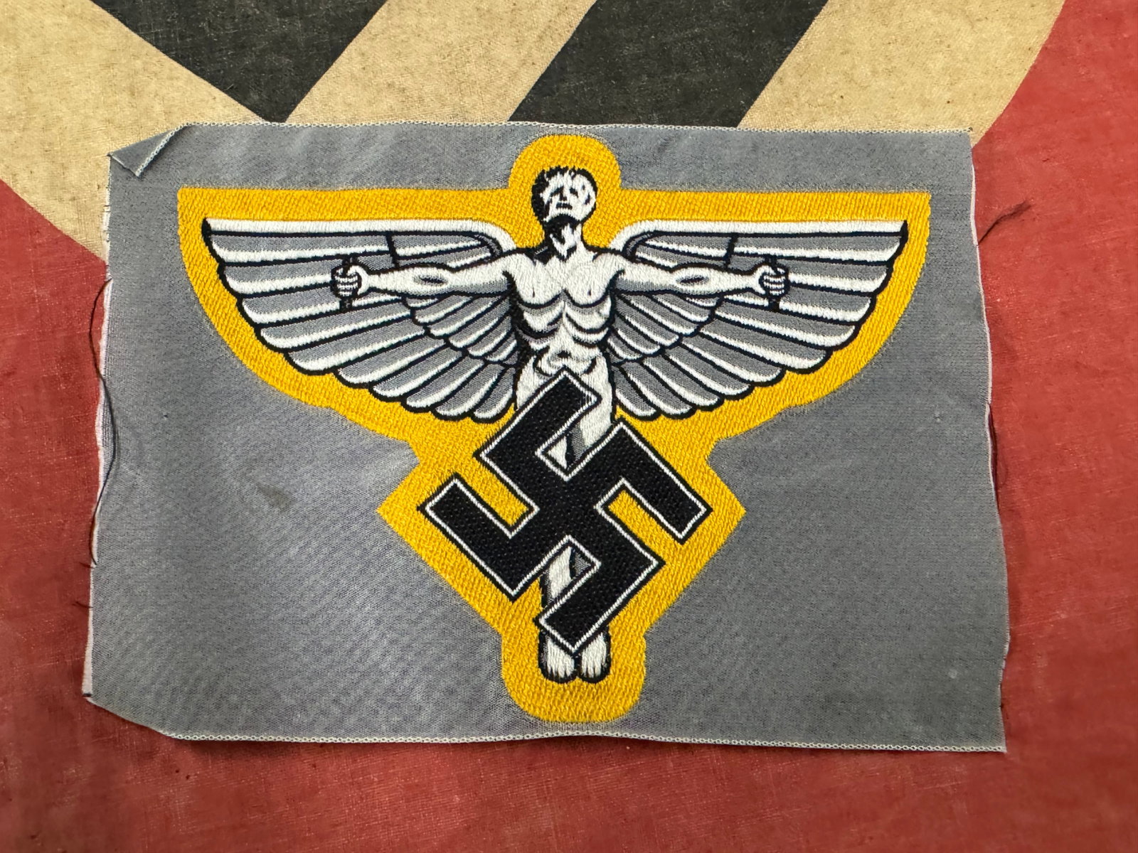 WW2 German NSFK Sports Vest Badge Insignia: WW2 German NSFK Sports Vest Badge Insignia. A rare find. Shows good wear and use with a beautiful overall patina. Please view all detailed pictures. A scarce example.