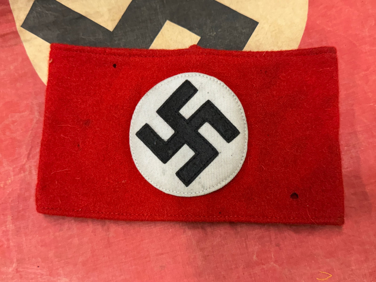 Early WWII SA Multi-piece Wool Felt & Rayon Overcoat Armband with RZM Tag: Early WWII SA Multi-piece Wool Felt & Rayon Overcoat Armband with RZM Tag. It features a rayon moire material white circle with a black multi-piece Swas (Hook Cross) patch, which is stitched onto the 