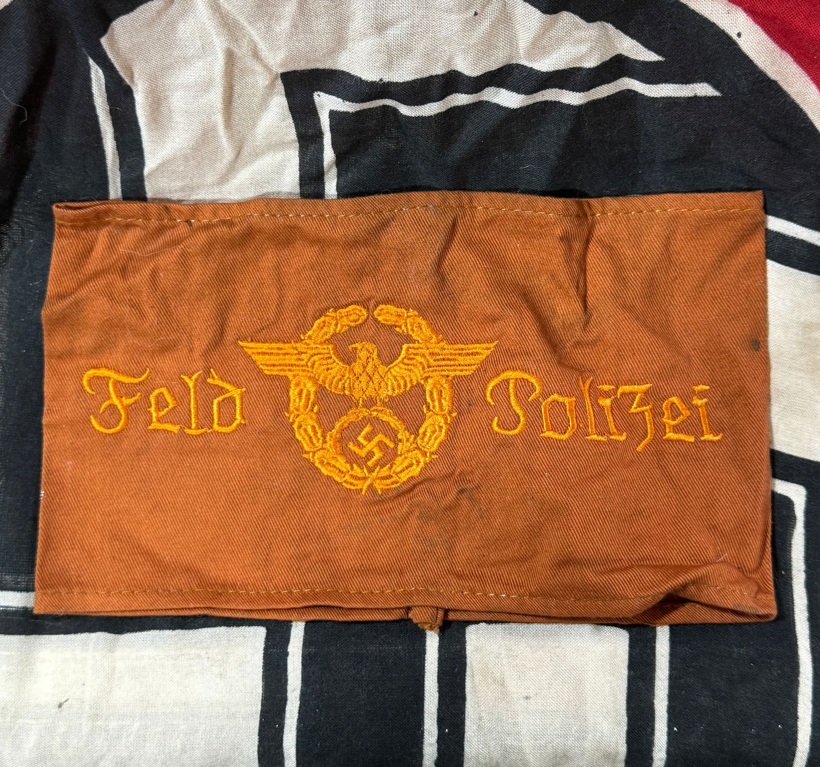 WWII GERMAN THIRD REICH FELD POLIZEI ARMBAND: German Field Police Feld Polizei EM armband. One piece machine embroidered and machine sewn brown cotton construction. Very good condition. Some fabric wear and slight staining present. Measures 7" X
