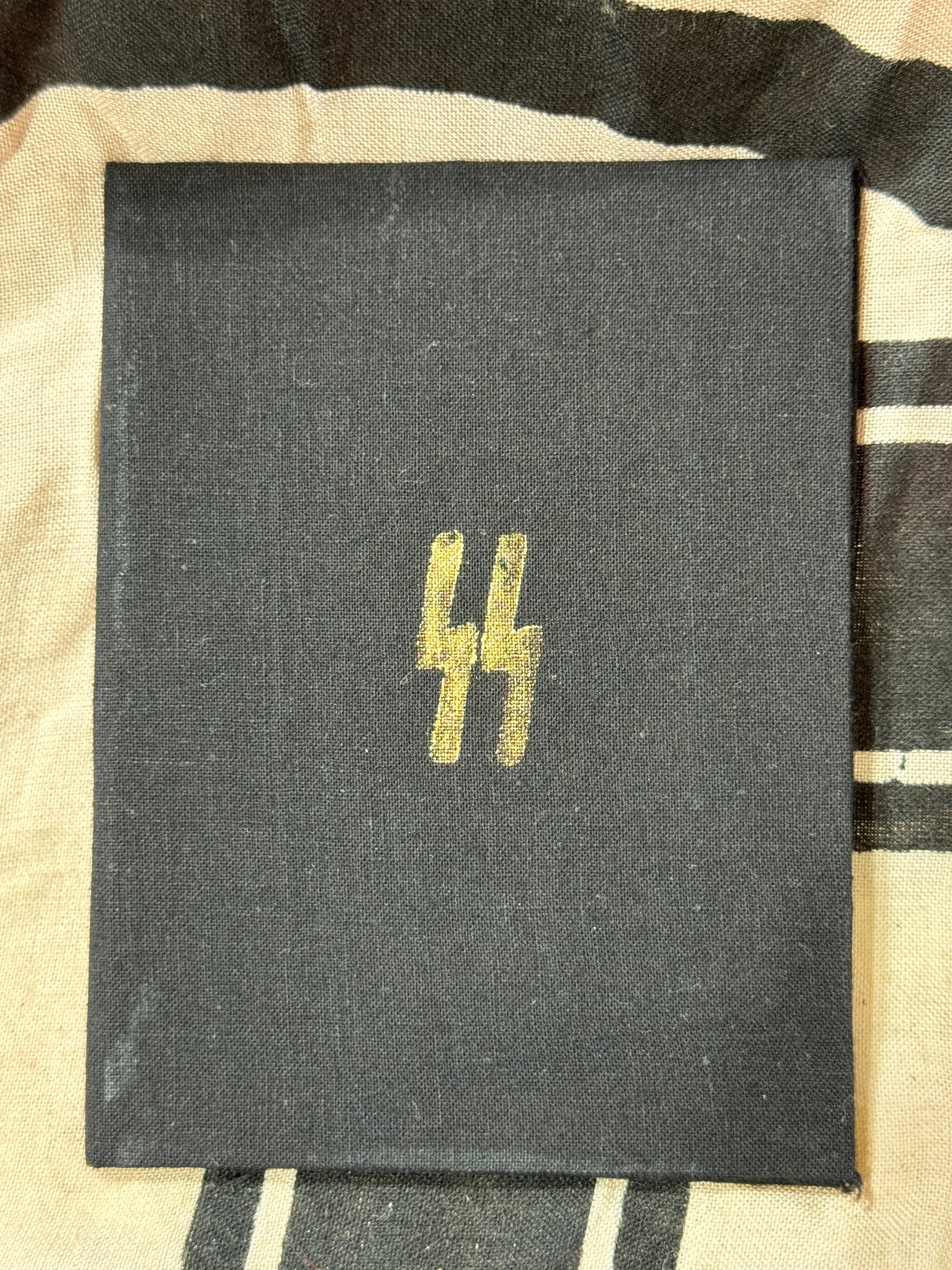WW2 GERMAN TOTENKOPF SS YOUNG SOLDIER'S ID BOOKLET WITH INSPECTION STAMP: WW2 GERMAN TOTENKOPF SS YOUNG SOLDIER'S ID BOOKLET WITH INSPECTION STAMP. AN ULTRA RARE FIND. SHOWS GOOD WEAR AND USE WITH A BEAUTIFUL OVERALL PATINA. THESE ARE VERY HARD TO COME ACROSS. PLEASE VIEW A