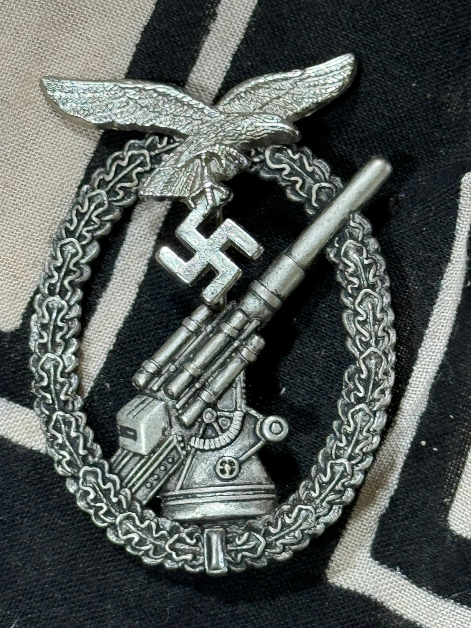 WW2 German Luftwaffe Flak badge – Adolf Scholze, Gablonz: WW2 German Luftwaffe Flak badge – Adolf Scholze, Gablonz. Early tombac flak with crimped ball hinge setup. Always unmarked but have been linked to A.S. production. Remains in very lightly worn to un