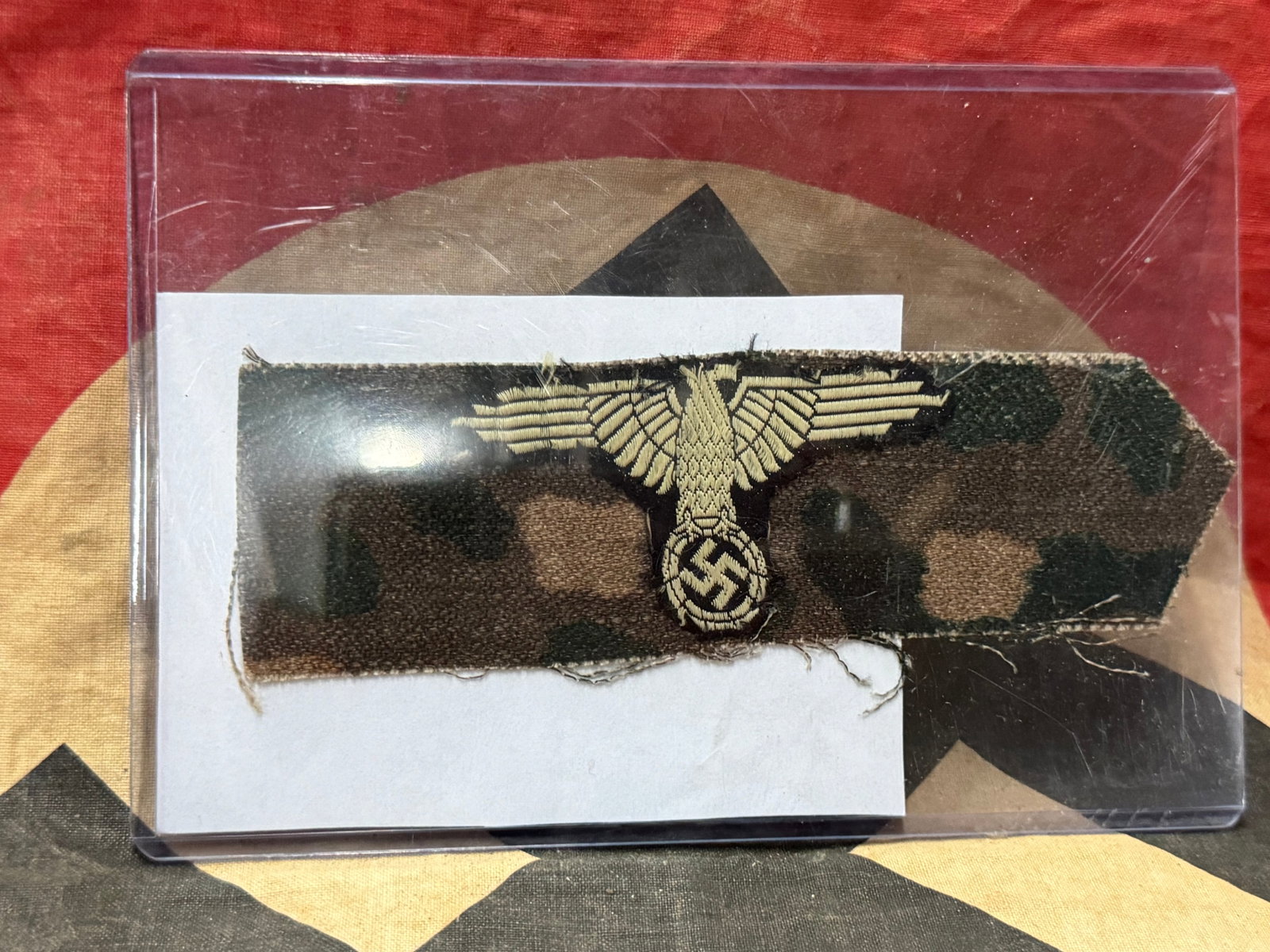 WW2 GERMAN WAFFEN SS CAMO SLEEVE EAGLE CUT OFF: WW2 GERMAN WAFFEN SS CAMO SLEEVE EAGLE CUT OFF. A VERY RARE FIND. SHOS GOOD WEAR AND USE. WAS CUT OUT AND BROUGHT BACK HOME BY A VET. VERY SCARCE EXAMPLE. PLEASE VIEW ALL DETAILED PICTURES.