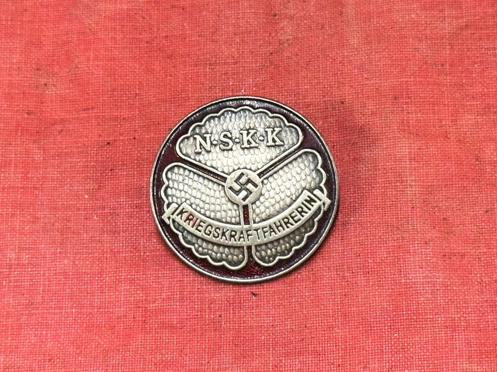 WW2 German NSKK Kriegs Kraftfahrerin Badge By RZM m1/35: WW2 German NSKK Kriegs Kraftfahrerin Badge By RZM m1/35. A rare example. Shows good wear and use with a beautiful overall patina. Beautiful enamel patina. Please view all detailed pictures. A scarce e
