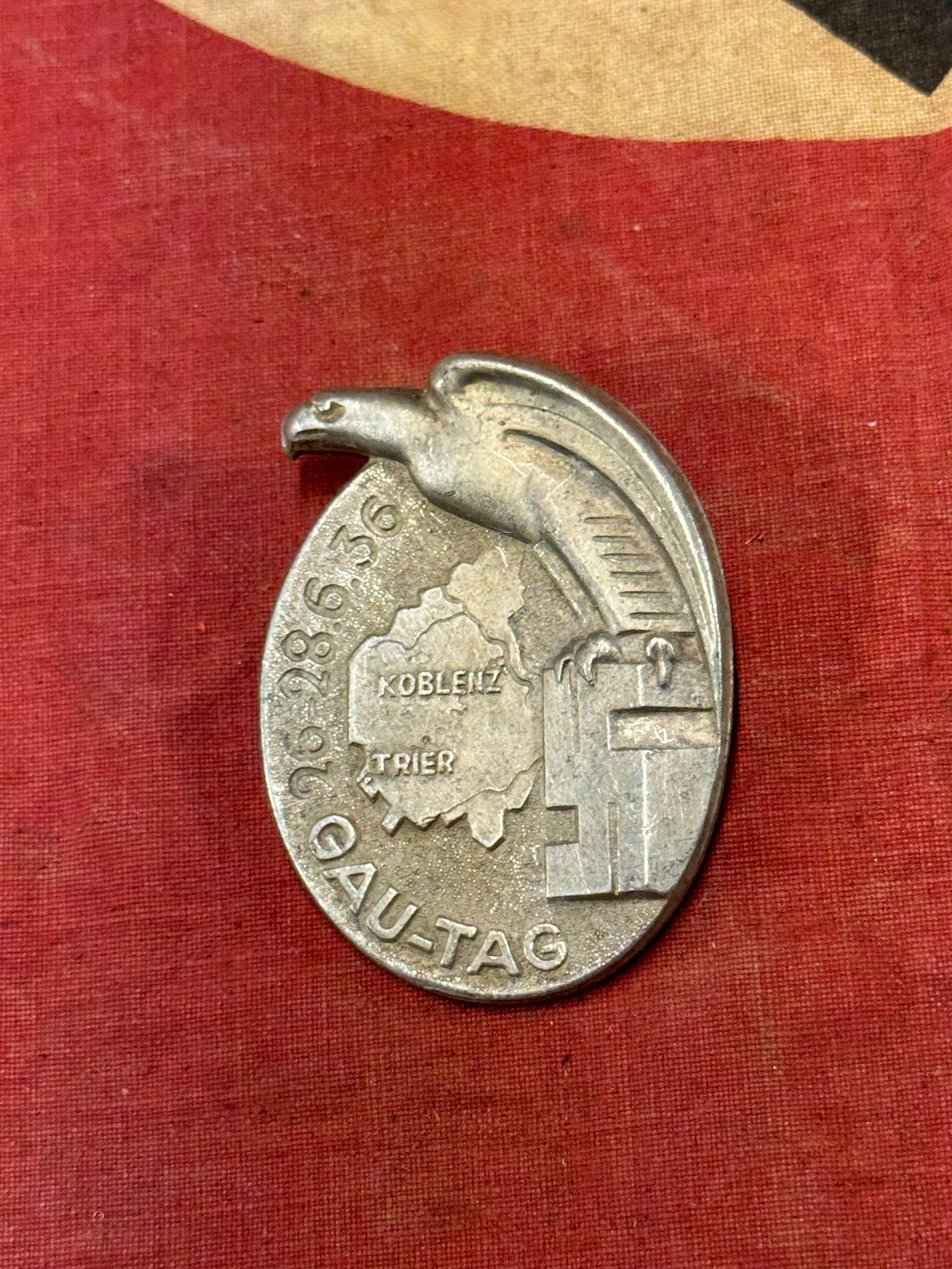 WW2 German NSDAP (NAZI PARTY) 1936 KOBLENZ-TRIER PROVINCIAL DAY BADGE: WW2 German NSDAP (NAZI PARTY) 1936 KOBLENZ-TRIER PROVINCIAL DAY BADGE. A RARE EXAMPLE. SHOWS GOOD WEAR AND USE WITH A BEAUTIFUL OVERALL PATINA. HOLLOW BACK CONSTRUCTION. Stamped aluminum badge, roughl