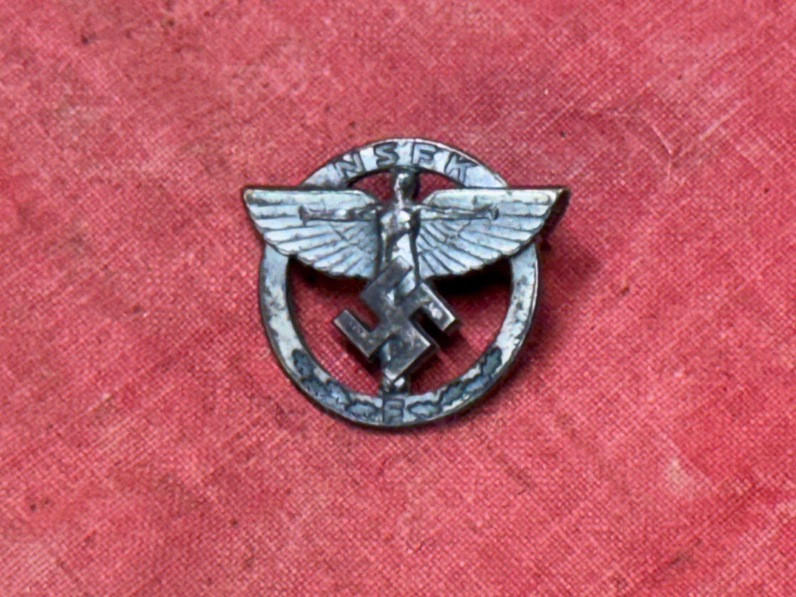 WW2 German NSFK Sponsoring Member Lapel Badge By Ges. Gesch.: WW2 German NSFK Sponsoring Member Lapel Badge By Ges. Gesch. Light wear to the matte silver finish, but overall very good condition, 1 inch wingspan.