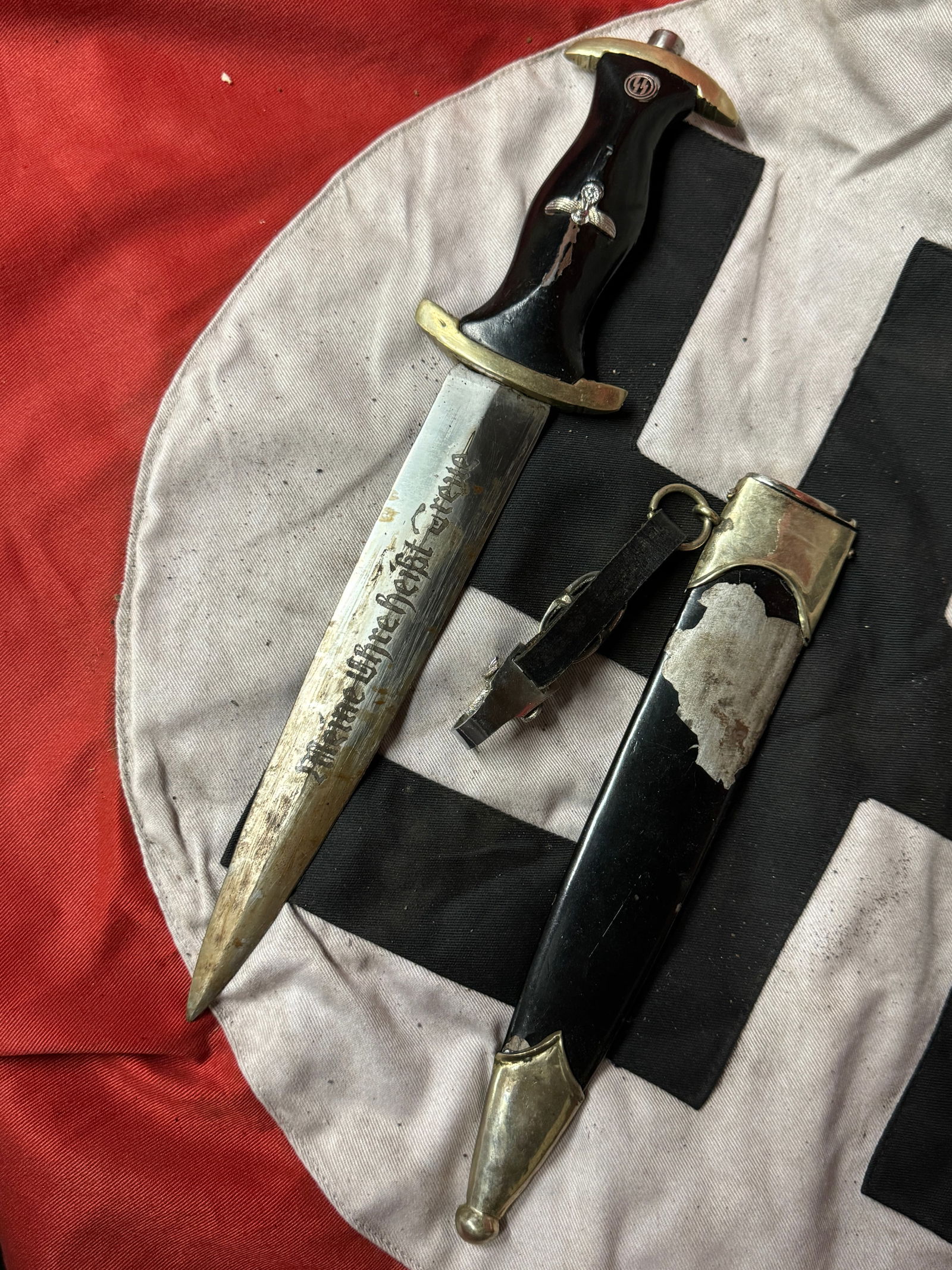 RARE WW2 GERMAN WAFFEN SS DAGGER BY RZM SS 21/38: RARE WW2 GERMAN WAFFEN SS DAGGER BY RZM SS 21/38. A RARE EXAMPLE. SHOWS GOOD WEAR AND USE WITH A BEAUTIFUL OVERALL PATINA. COMES WITH THE ORIGINAL SCABBARD AND ETCHED BLADE "MEINE EHRE HEIBT TREUE". P