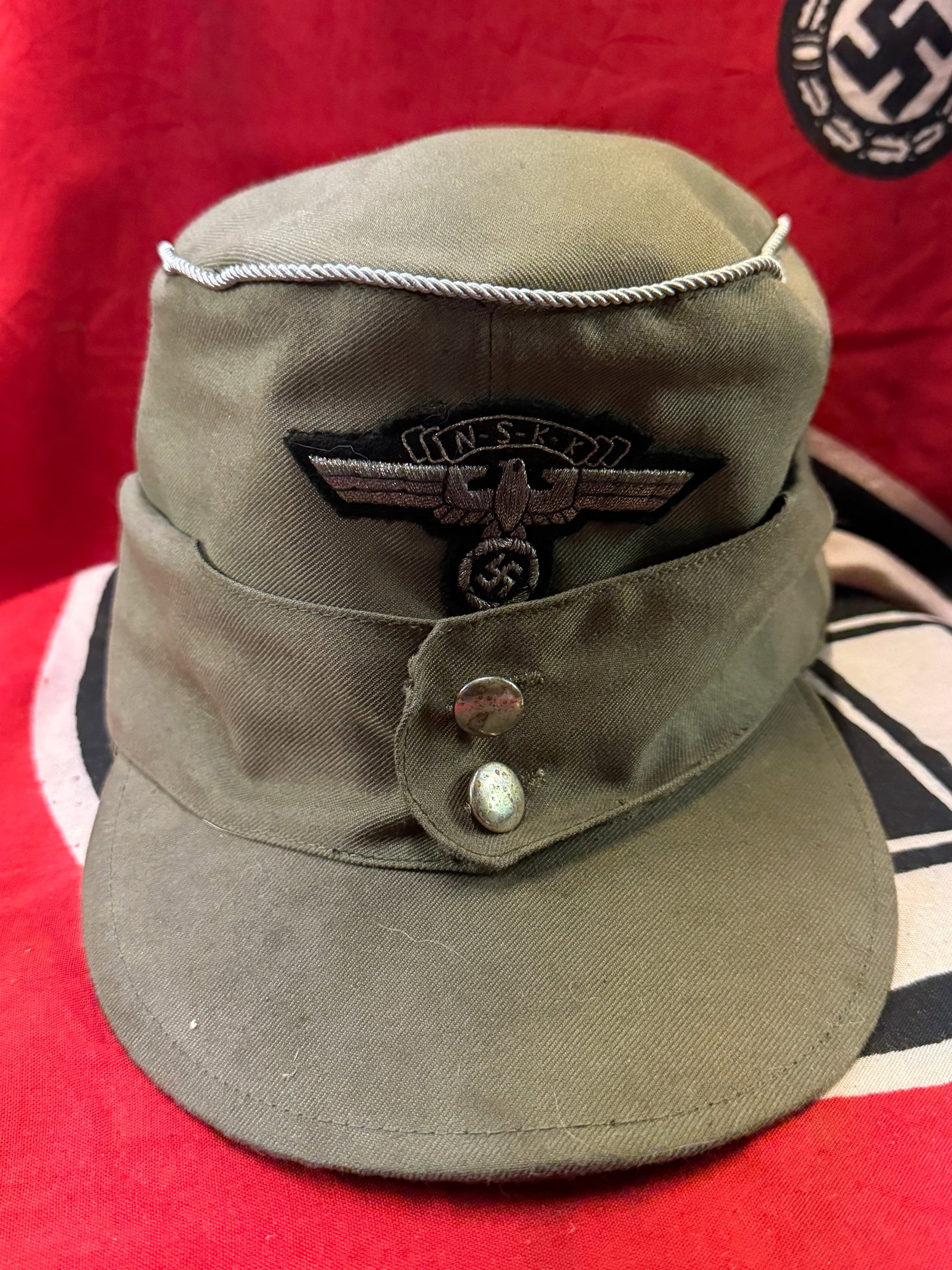 SCARCE WW2 GERMAN NSKK LEADER CAP: SCARCE WW2 GERMAN NSKK LEADER CAP. A VERY RARE FIND. SHOWS GOOD WEAR AND USE WITH A BEAUTIFUL OVERALL PATINA. APPEARS TO BE VERY WELL WORN. PLEASE VIEW ALL DETAILED PICTURES. A SCARCE EXAMPLE.