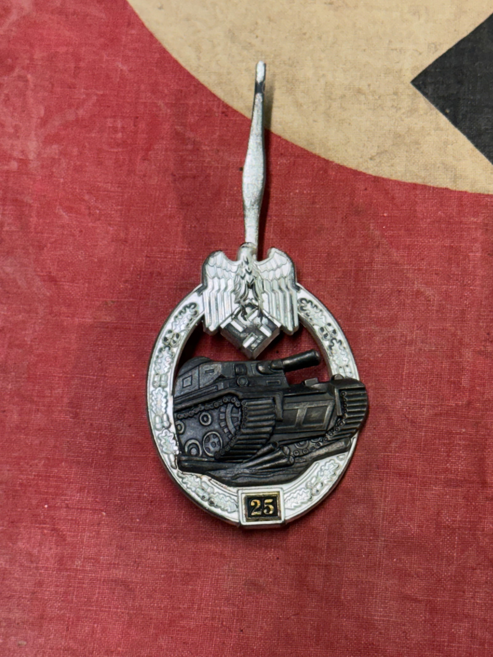 WW2 German 25 Engagement Panzer Assault Badge in Silver By JFS: WW2 German 25 Engagement Panzer Assault Badge in Silver By JFS. A scarce find. Shows good wear and use with a beautiful overall patina. Please view all detailed pictures. A scarce example.