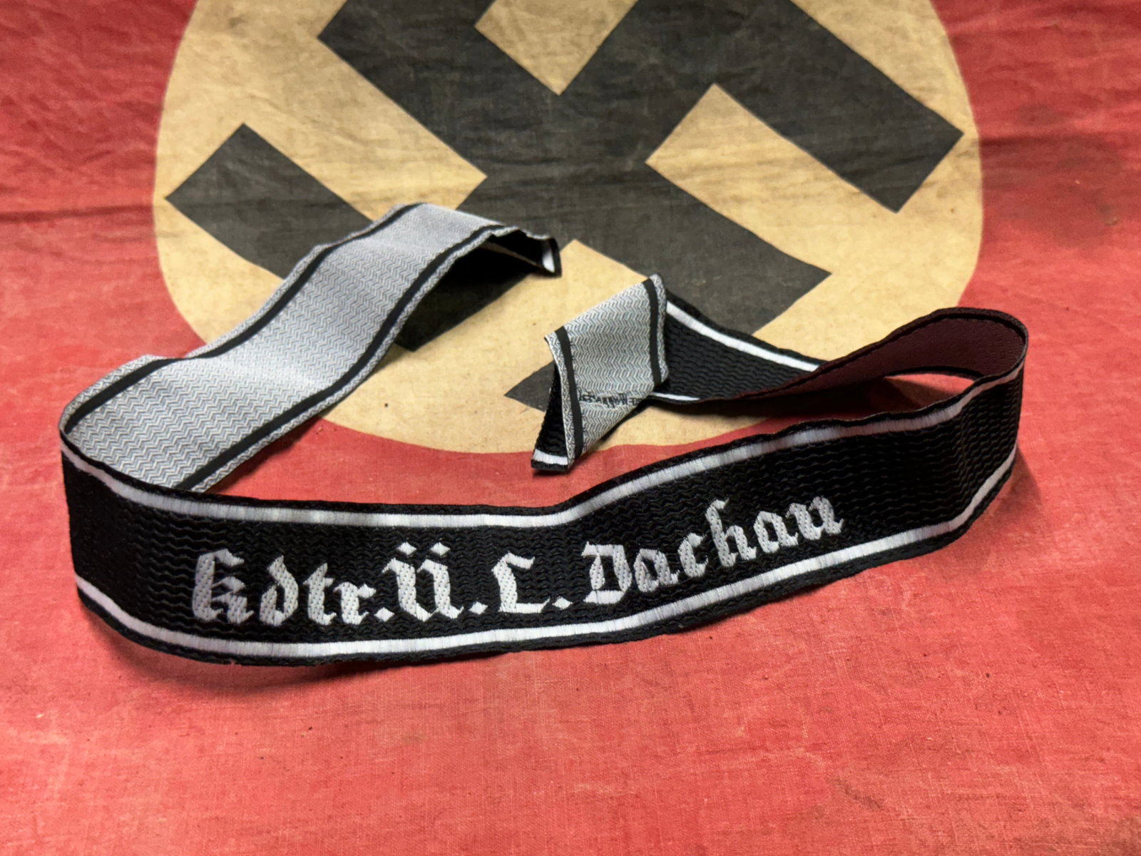 WW2 German Kdre.U.L.Dachau Brassard, Waffen SS Cuff Title: WW2 German Kdre.U.L.Dachau Brassard, Waffen SS Cuff Title. A rare find. Shows good wear and use with a beautiful overall patina. Please view all detailed pictures.