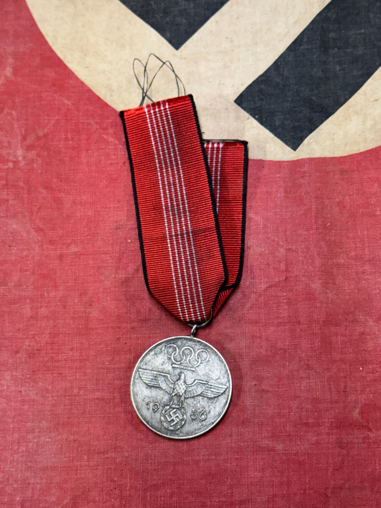 WW2 German 1936 Olympic Games Medal: WW2 German 1936 Olympic Games Medal. The medal shows wear and uncleaned patina to the silver finish, but exhibits fine detail.