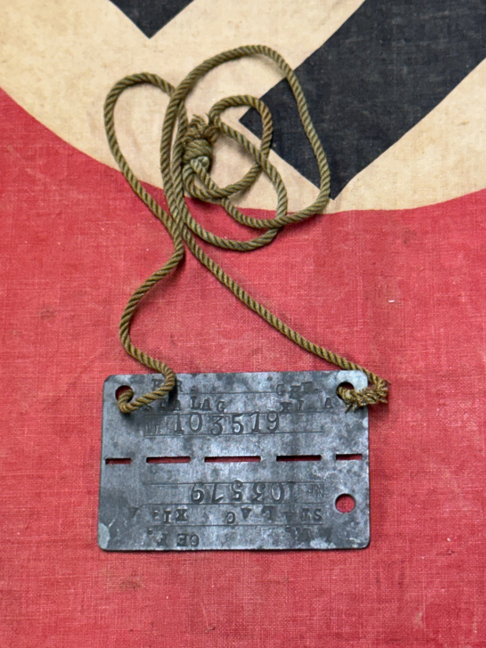 RARE WW2 GERMAN SOLDIER DOG TAG - COMPLETE WITH BULLION CORD: RARE WW2 GERMAN SOLDIER DOG TAG - COMPLETE WITH BULLION CORD. A SCARCE FIND. SHOWS GOOD WEAR AND USE WITH A BEAUTIFUL OVERALL PATINA. PLEASE VIEW ALL DETAILED PICTURES. A RARE FIND.