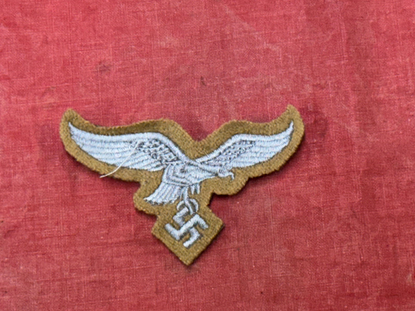WW2 German Luftwaffe EM/NCO chest tropical eagle insignia: WW2 German Luftwaffe EM/NCO chest tropical eagle insignia. Embroidered on khaki cotton fabric. A rare find. Please view all detailed pictures.