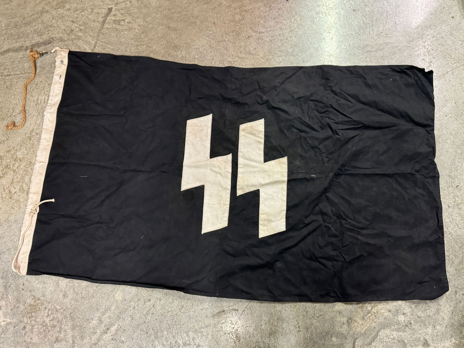 RARE WW2 GERMAN WAFFEN SS FLAG BY RZM SS: RARE WW2 GERMAN WAFFEN SS FLAG BY RZM SS. A SCARCE EXAMPLE. SHOWS GOOD WEAR AND USE WITH A BEAUTIFUL OVERALL PATINA. PLEASE VIEW ALL DETAILED PICTURES. A SCARCE EXAMPLE.