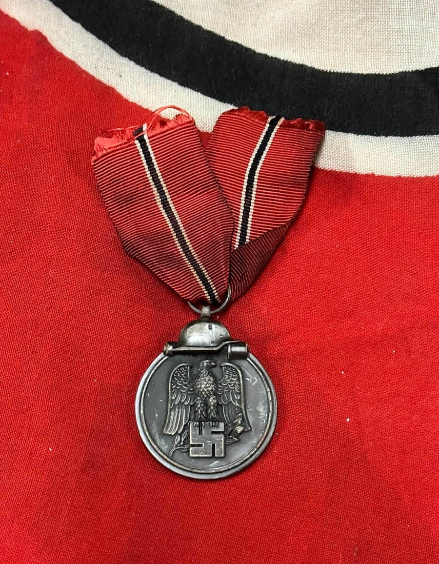 RARE WW2 GERMAN EAST MEDAL WITH RIBBON: RARE WW2 GERMAN EAST MEDAL WITH RIBBON. Silvered zinc, 35.5 mm. Shows good wear and use with a beautiful overall patina. Please view all detailed pictures. A scarce example.