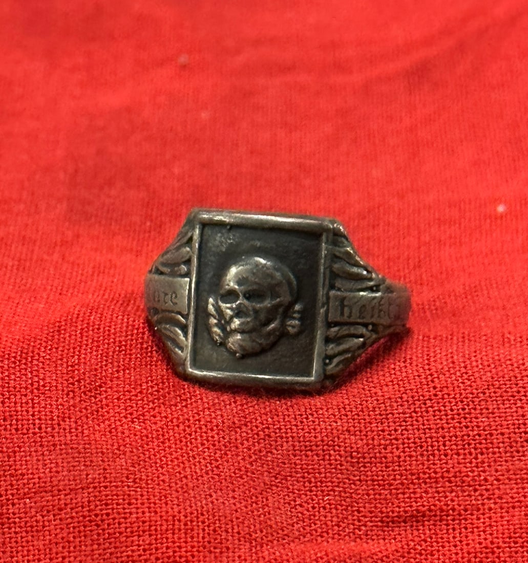 WW2 GERMAN SS TOTENKOPF SKULL SIGNET RING MARKED SS: WW2 GERMAN SS TOTENKOPF SKULL SIGNET RING MARKED SS. A RARE SILVER RING THAT IS IN MINT OVERALL SHAPE AND CONDITION WITH A BEAUTIFUL OVERALL PATINA. SHOWS GOOD WEAR AND USE. MARKED SS ON THE INSIDE. A