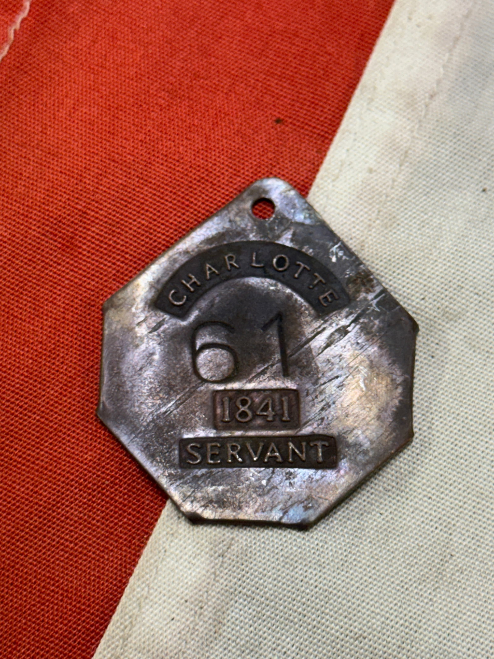 DATED 1841 CHARLOTTE #61 SERVANT SLAVE ID TAG: DATED 1841 CHARLOTTE #61 SERVANT SLAVE ID TAG. A VERY RARE FIND. IT IS IN MINT OVERALL SHAPE AND CONDITION WITH A BEAUTIFUL OVERALL PATINA. A RARE FIND AND AN EXCELLENT ADDITION TO YOUR COLLECTION.