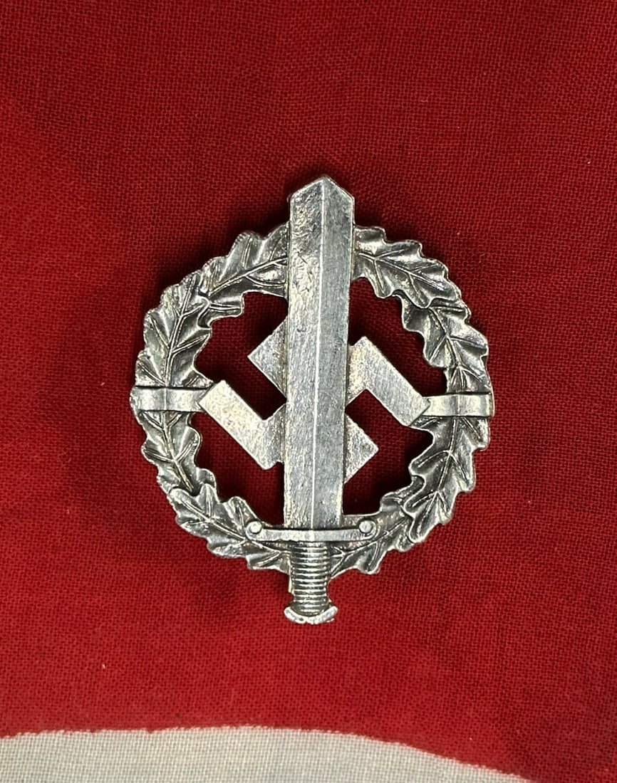 WW2 GERMAN SA SPORTS BADGE SILVER GRADE BY WERNER REDO OF SAAR-LAUTERN: WW2 GERMAN SA SPORTS BADGE SILVER GRADE BY WERNER REDO OF SAAR-LAUTERN. (SA-Sportabzeichen in Silber). Instituted November 28th, 1933. Constructed of silvered magnetic metal, the obverse consists of a