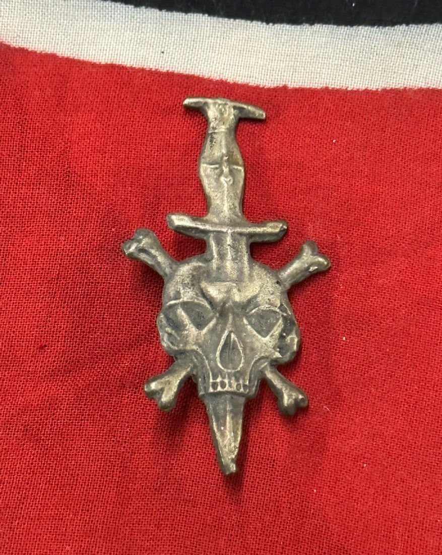 WW2 SS Skull with Cross Bones Dagger Pin Death Biker Badge - Silver: WW2 SS Skull with Cross Bones Dagger Pin Death Biker Badge - Silver. A rare find. Shows good wear and use with a beautiful overall patina. Please view all detailed pictures. A scarce example.
