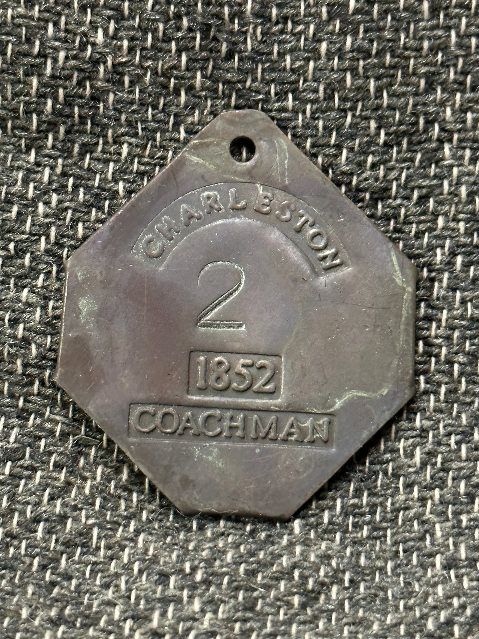 DATED 1852 CHARLESTON COACHMAN #2 SLAVE TAG SERVANT ID: DATED 1852 CHARLESTON COACHMAN #2 SLAVE TAG SERVANT ID. A VERY RARE EXAMPLE. SHOWS GOOD WEAR AND USE WITH A BEAUTIFUL OVERALL PATINA. PLEASE VIEW ALL DETAILED PICTURES. A SCARCE EXAMPLE.