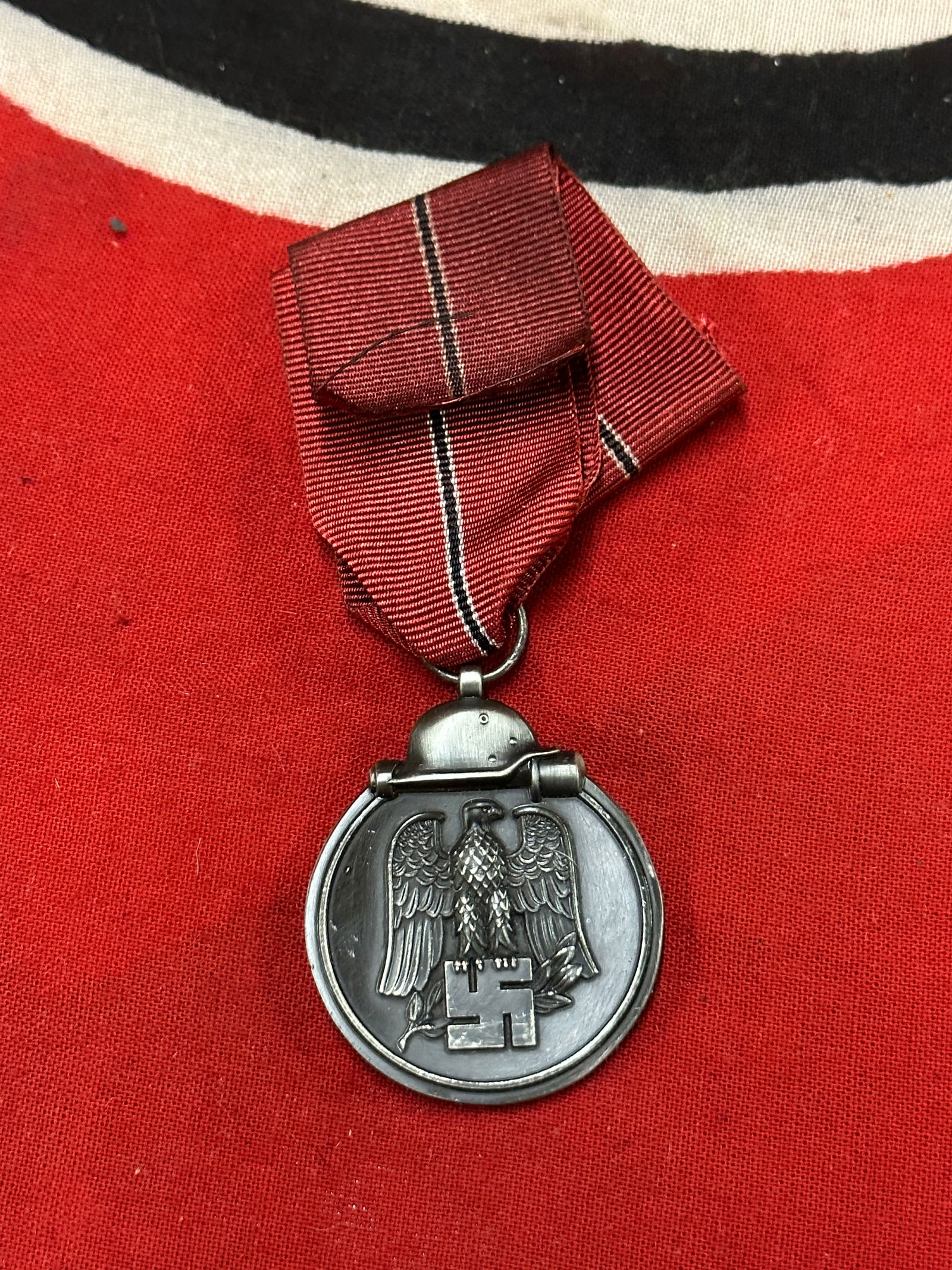 RARE WW2 GERMAN EASTERN FRONT MEDAL WITH RIBBON: RARE WW2 GERMAN EASTERN FRONT MEDAL WITH RIBBON. A SCARCE FIND. SHOWS GOOD WEAR AND USE WITH A BEAUTIFUL OVERALL PATINA. A VERY RARE EXAMPLE.